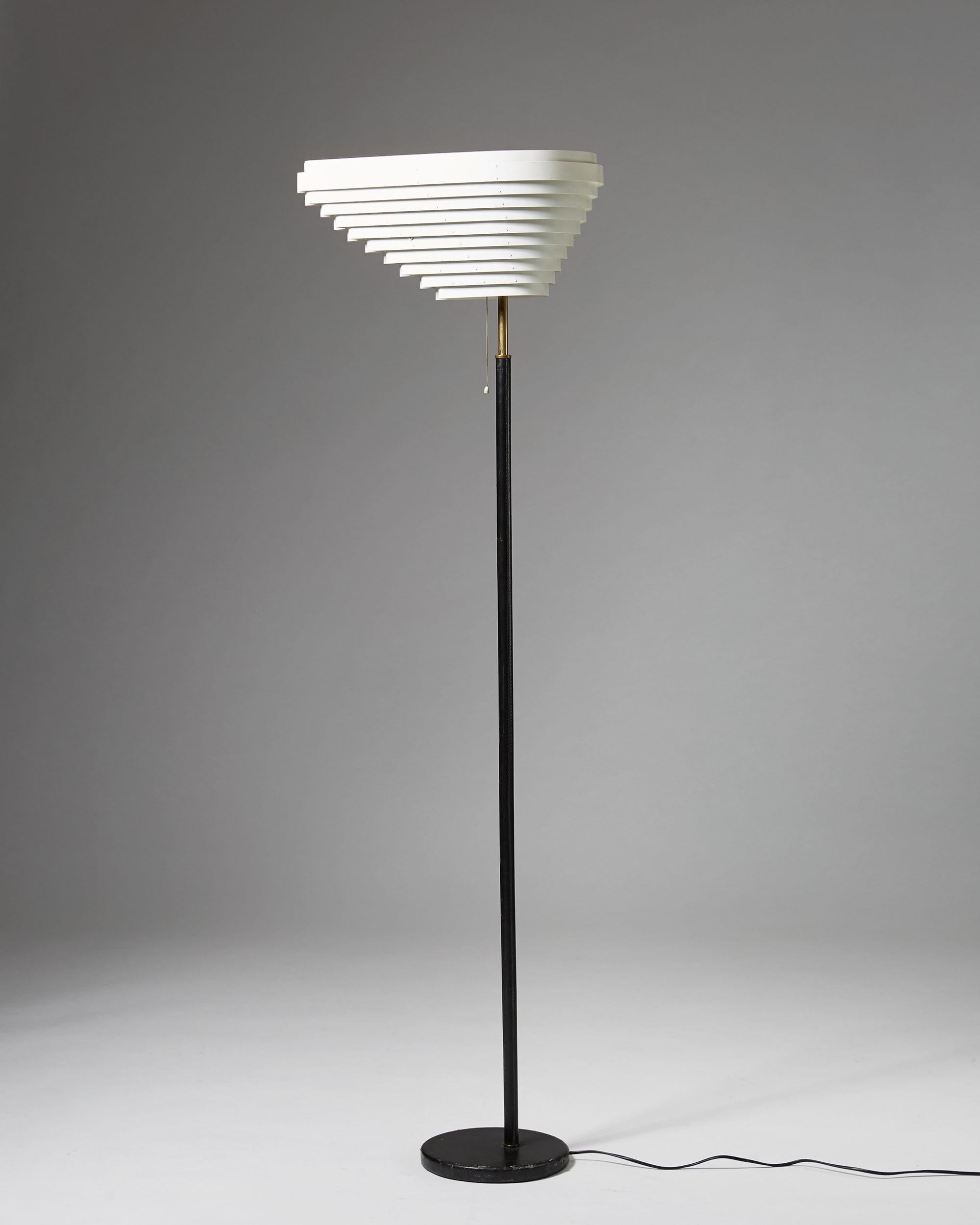 Shade white painted steel. Base and shaft covered with black leather. Polished brass fittings.

Measurements: 
H: 170,5 cm/ 5' 7 5/8''
W: 35 cm / 13 3/4''
D: 52 cm/ 20 1/2''

Alvar Aalto was a Finnish architect and designer. His work includes
