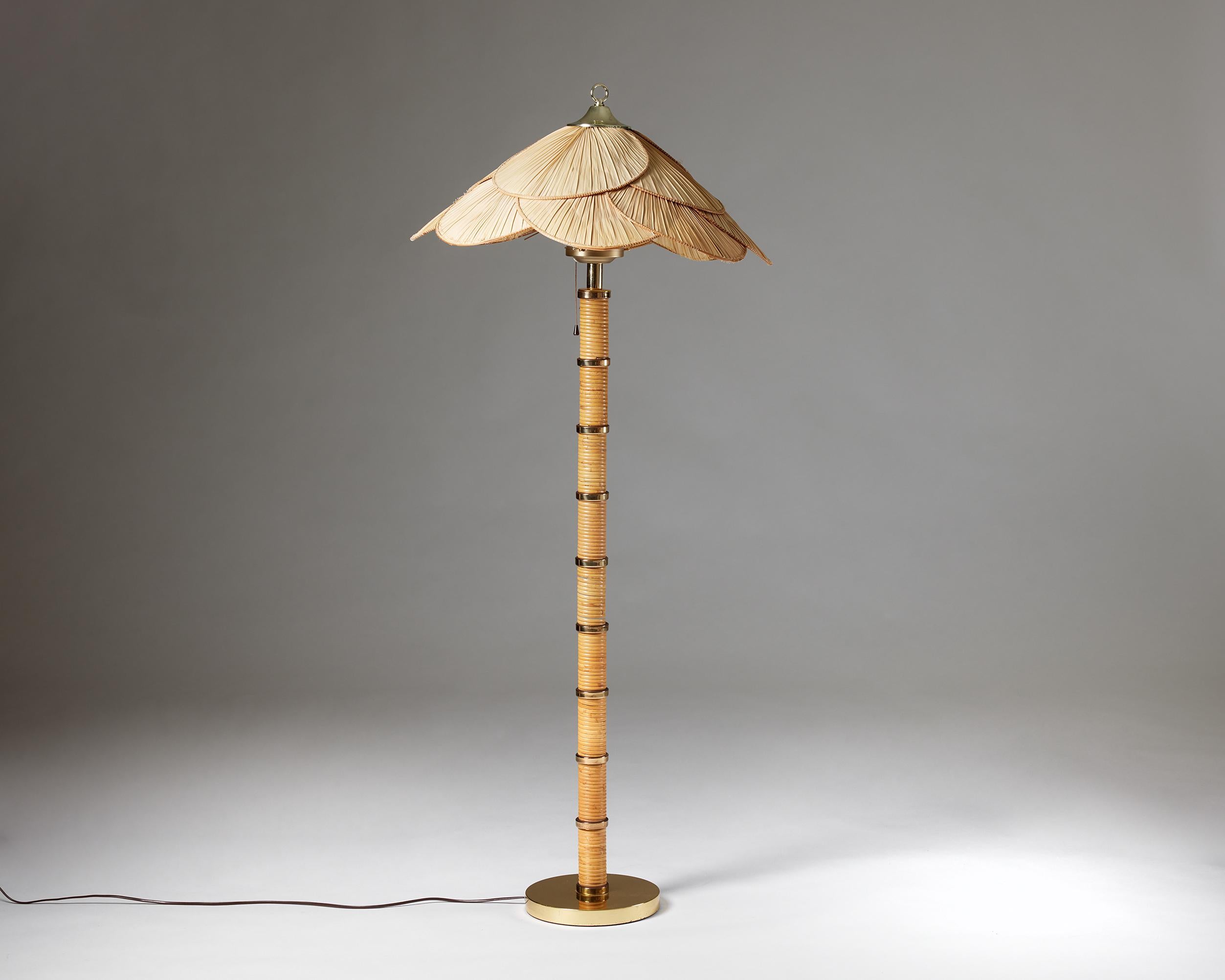 Floor lamp, anonymous,
Sweden, 1970s.

Brass, cane and opal glass.
