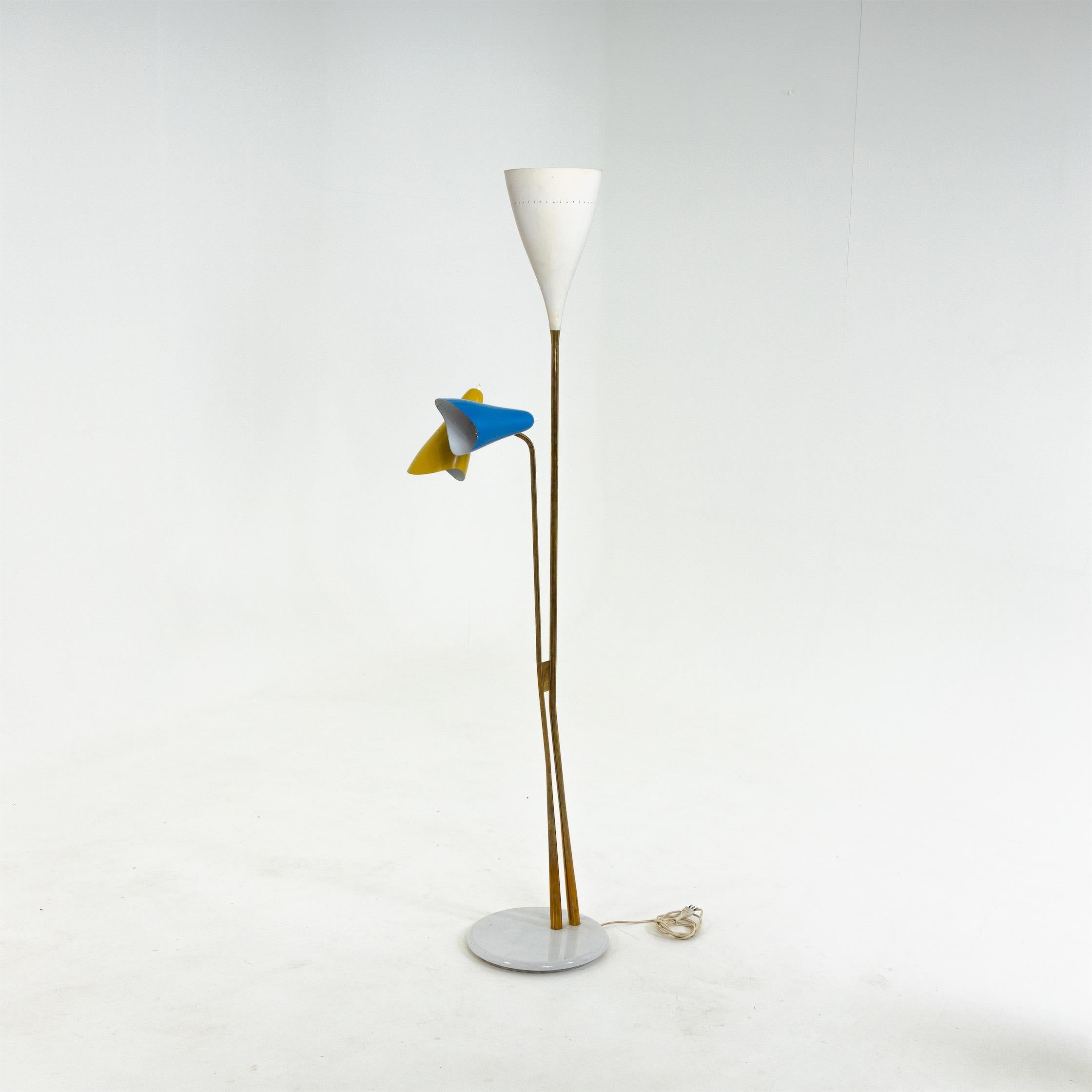 Lamp standing on a round marble base with brass stem and conical lampshades in white, blue and yellow.