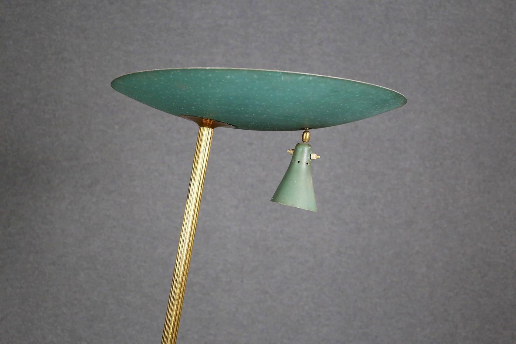 Pure Italian design. Floor lamp attributed to Studio BBPR of the 1930s and 1940s. The lamp has as base two iron tips in the shape of forked. The stem is made of tubular brass and its semi-circular hat is made of green iron. From the hat you can see