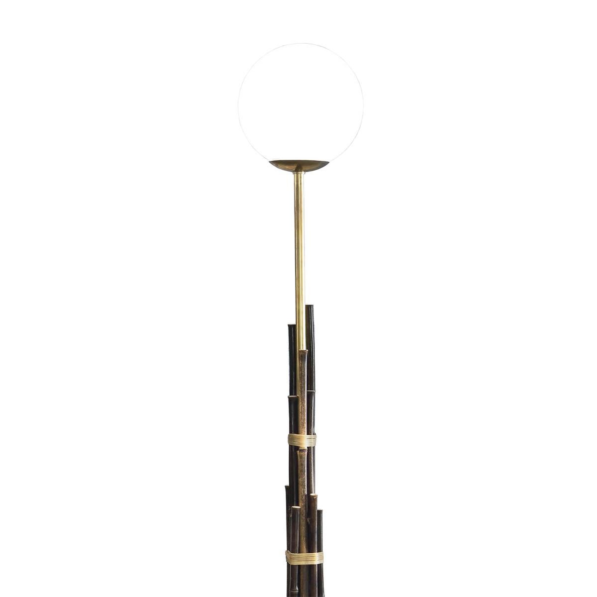 Floor Lamp Bamboos Medium with black bamboo,
With solid painted brass rod with opal glass shade.
Wiring 14W bulb, 220Volt and switch included, lamp
Holder type E27, bulb not included. On casted iron, 
Measures: Base, 30cm diameter.
Available in