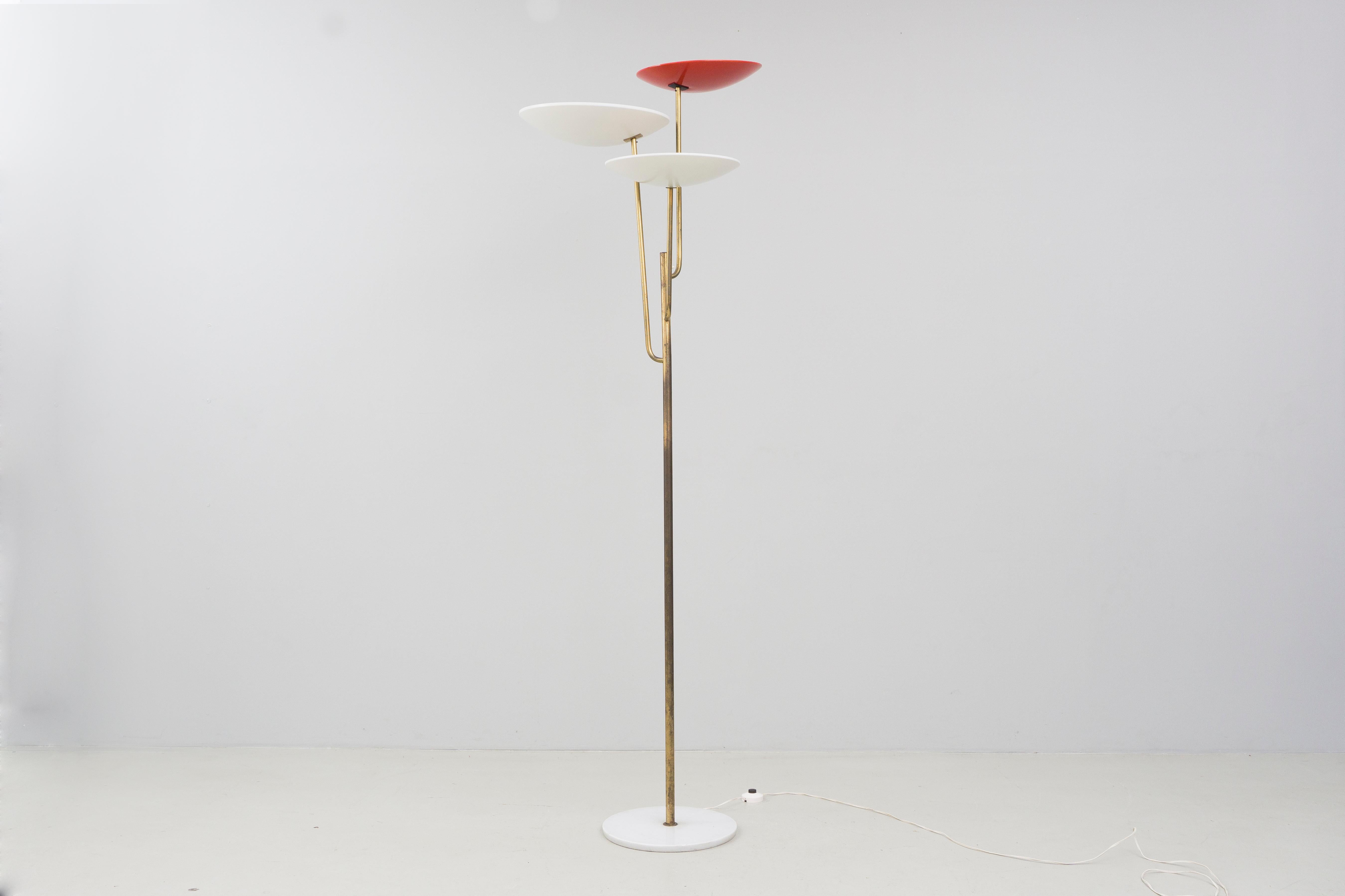 Elegant brass floor lamp by Bruno Gatta and produced by Stilnovo, Italy in 1953.
The lamp has three reflectors and a marble lampstand. The manufacturers logo is visible inside of the lampshade.

This lamp is especially extravagant due to its