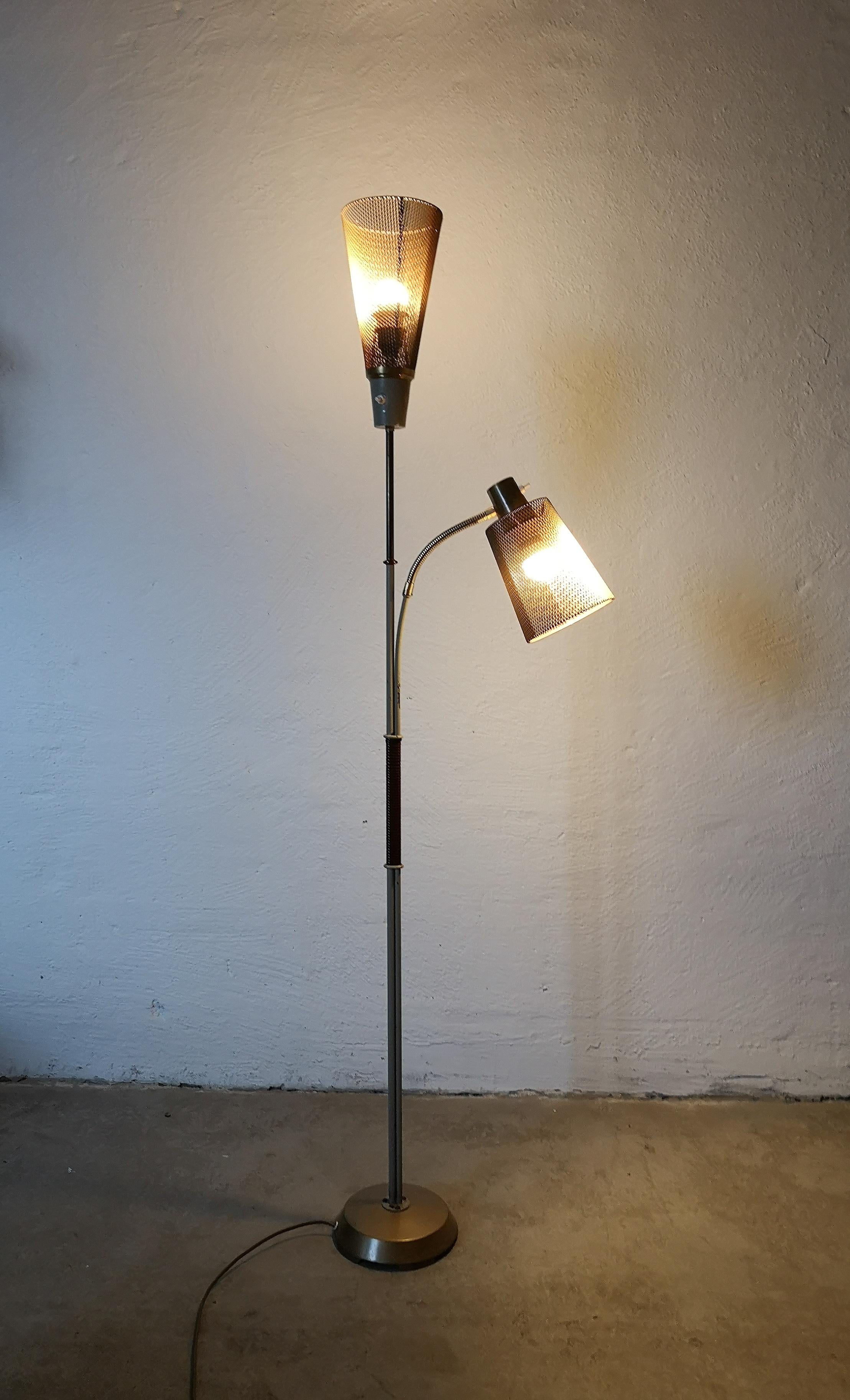 This floor lamp was created and designed by Einar Bäckström Malmö Sweden in the early 1960s. It’s made in painted metal and brass foot. The shades are in brass. It was created so that you could choose if you wanted upplight or reading light. It