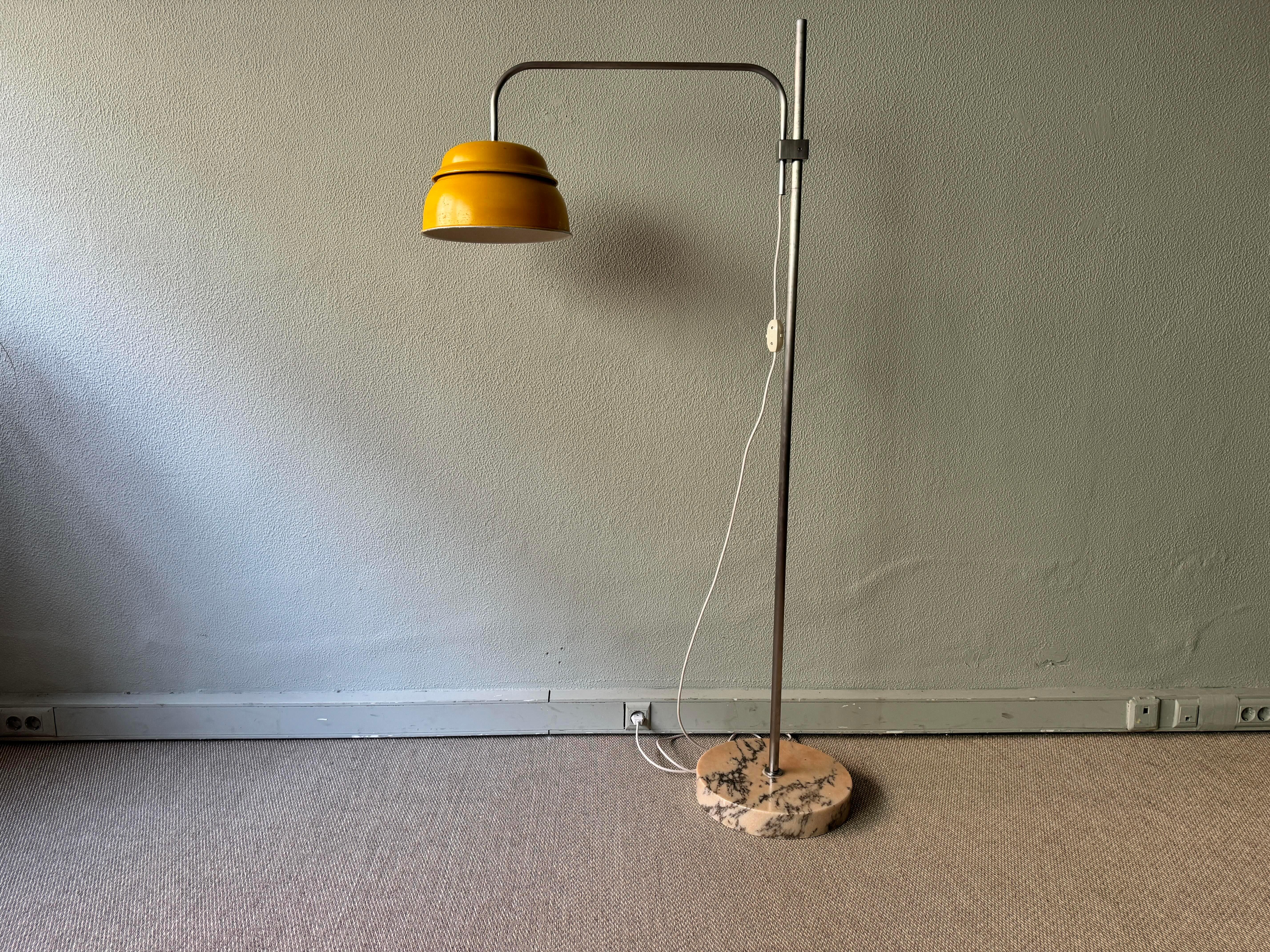 Add a touch of vintage elegance to your living space with this stunning floor lamp by Francisco Conceição Silva, a renowned designer from Portugal in the 1970's. The brushed steel stem and yellow painted metal diffuser create a sleek and modern