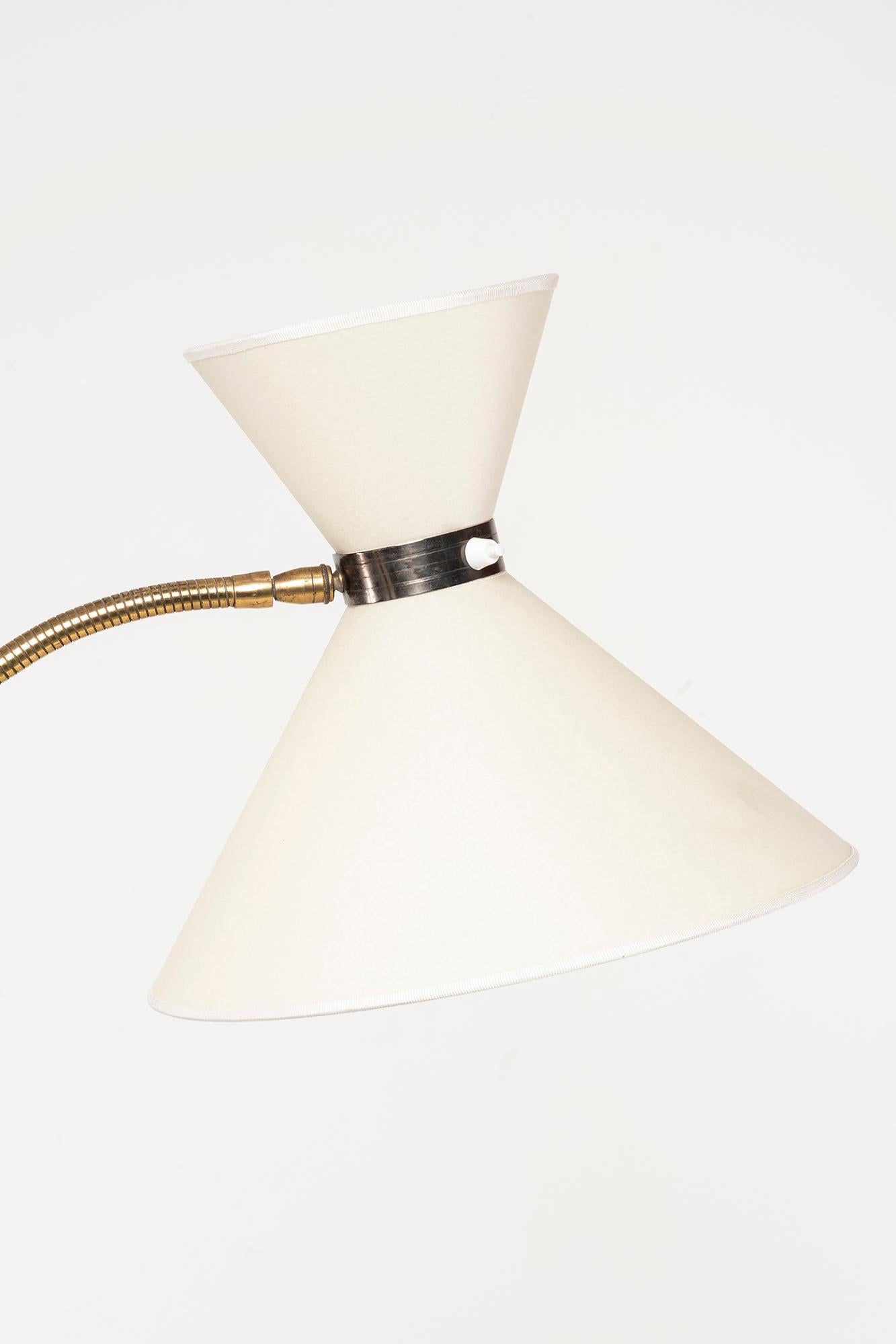 France, 1955
Brass stand and base, partially refined in dark grey, parchment lampshade.