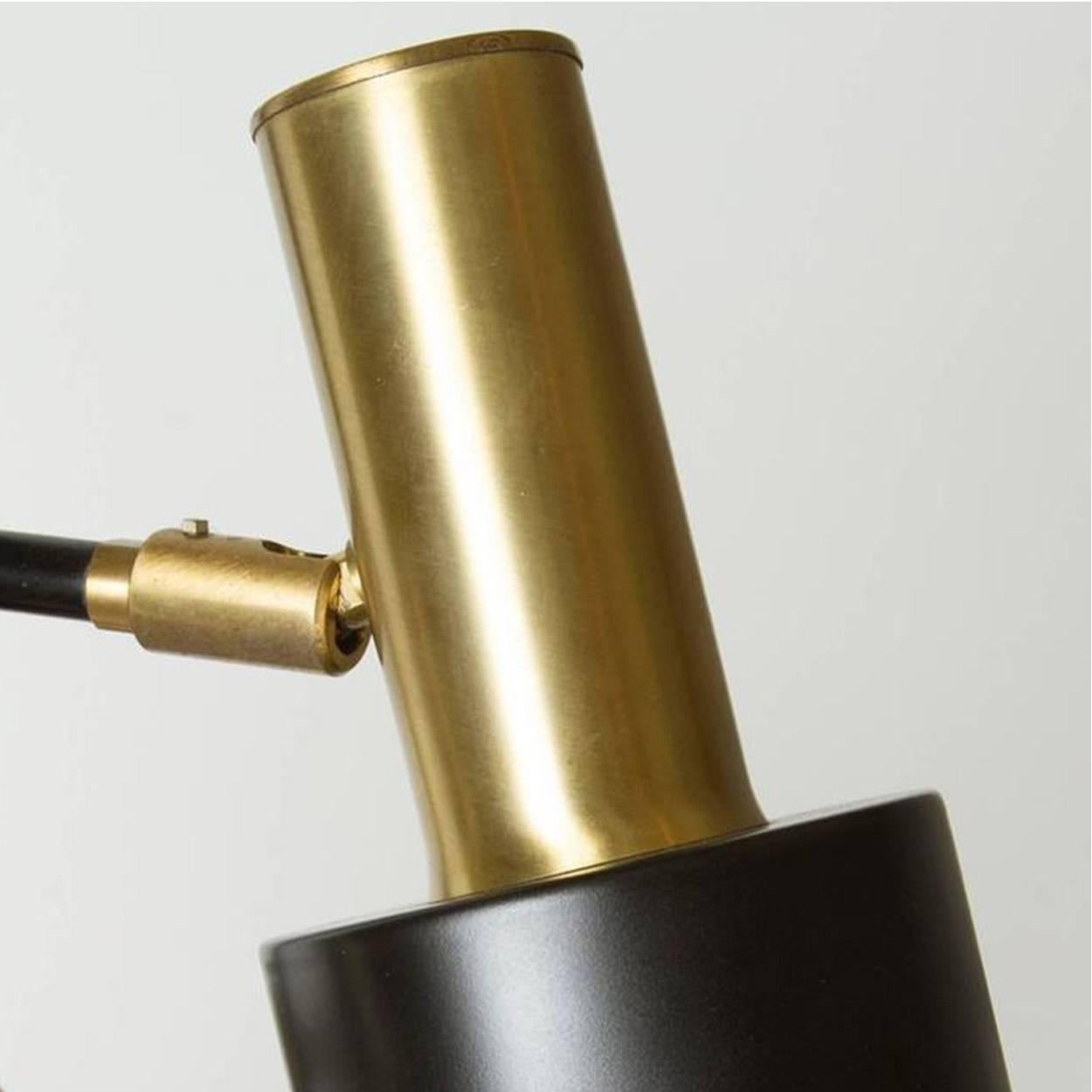 A three cone adjustable floor lamp designed by Jo Hammerborg for Fog & Mørup, Denmark, circa 1960s. Made of brass and black lacquered metal. The he light is iconic for Danish lighting design. A very warm light due to materials and color.

The lamp