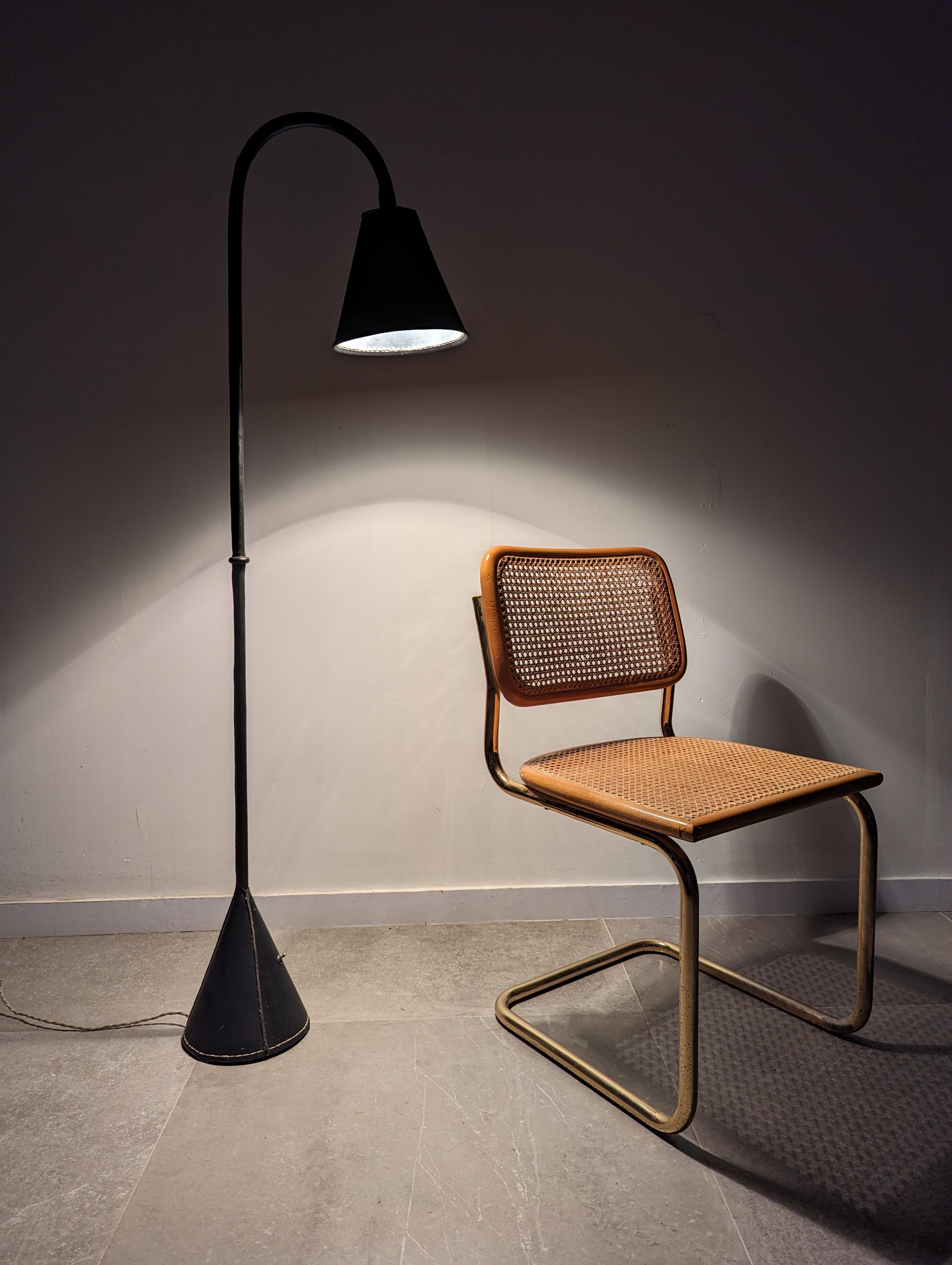 Fantastic floor lamp by the great French designer and architect Jacques Adnet made of black leather and sewn by hand.