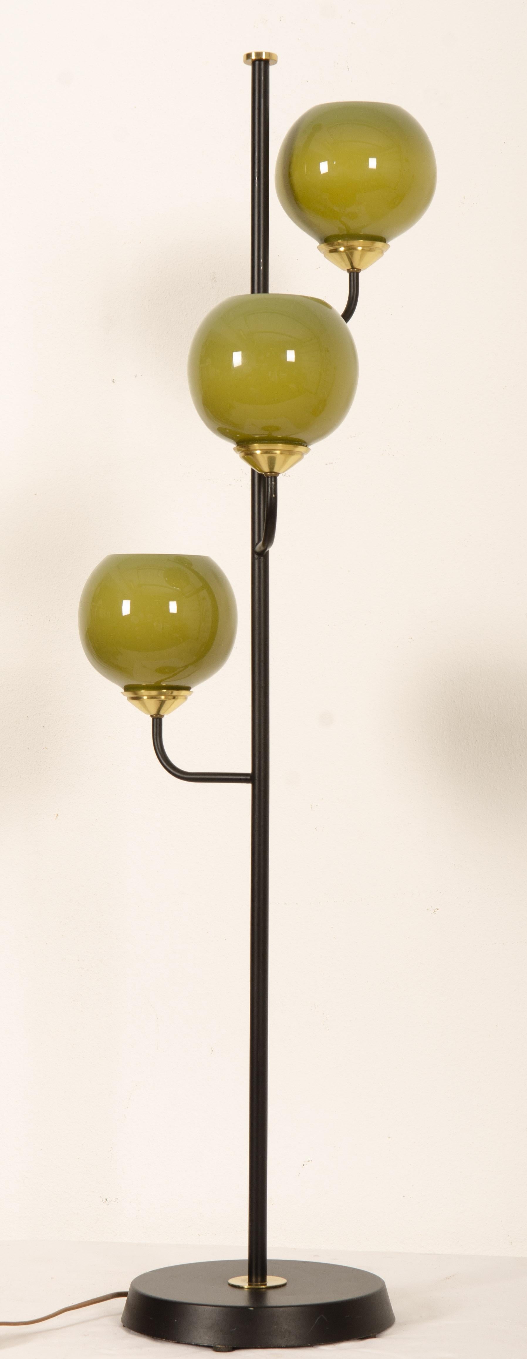 Cast iron base, three arms with green glass ball shaped shades and fitted each with E27 bakelite sockets. Designed in Sweden in the 1970s.