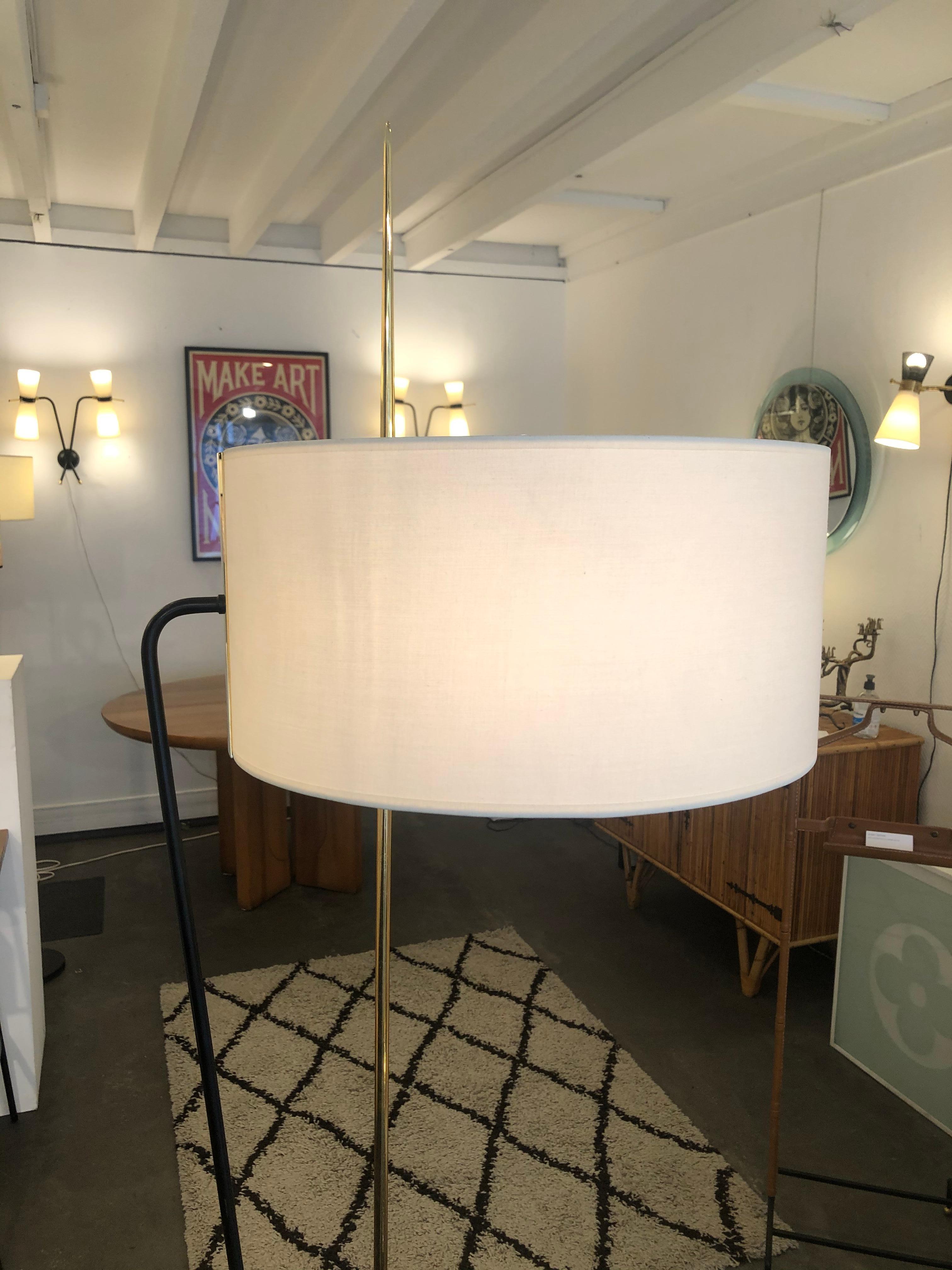 Floor lamp by Maison Arlus from 1950
It is in black lacquered metal and brass 
With fabric shade.