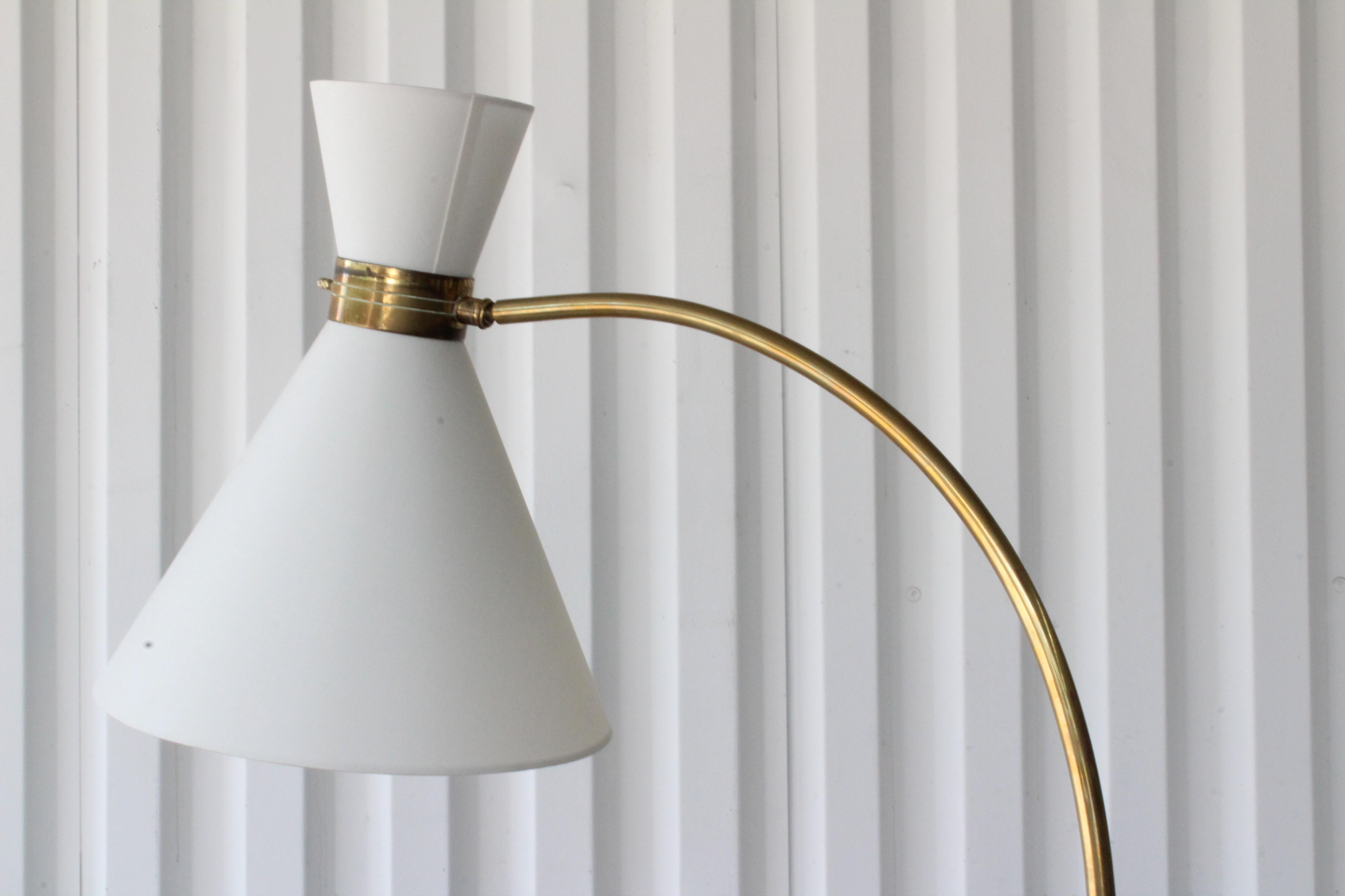 Vintage 1950s floor lamp by Maison Lunel, France. Features a brass stem on a red enameled iron base. Newly rewired and fitted with new custom shades in silk. In excellent condition with a nice patina to the brass and iron base.