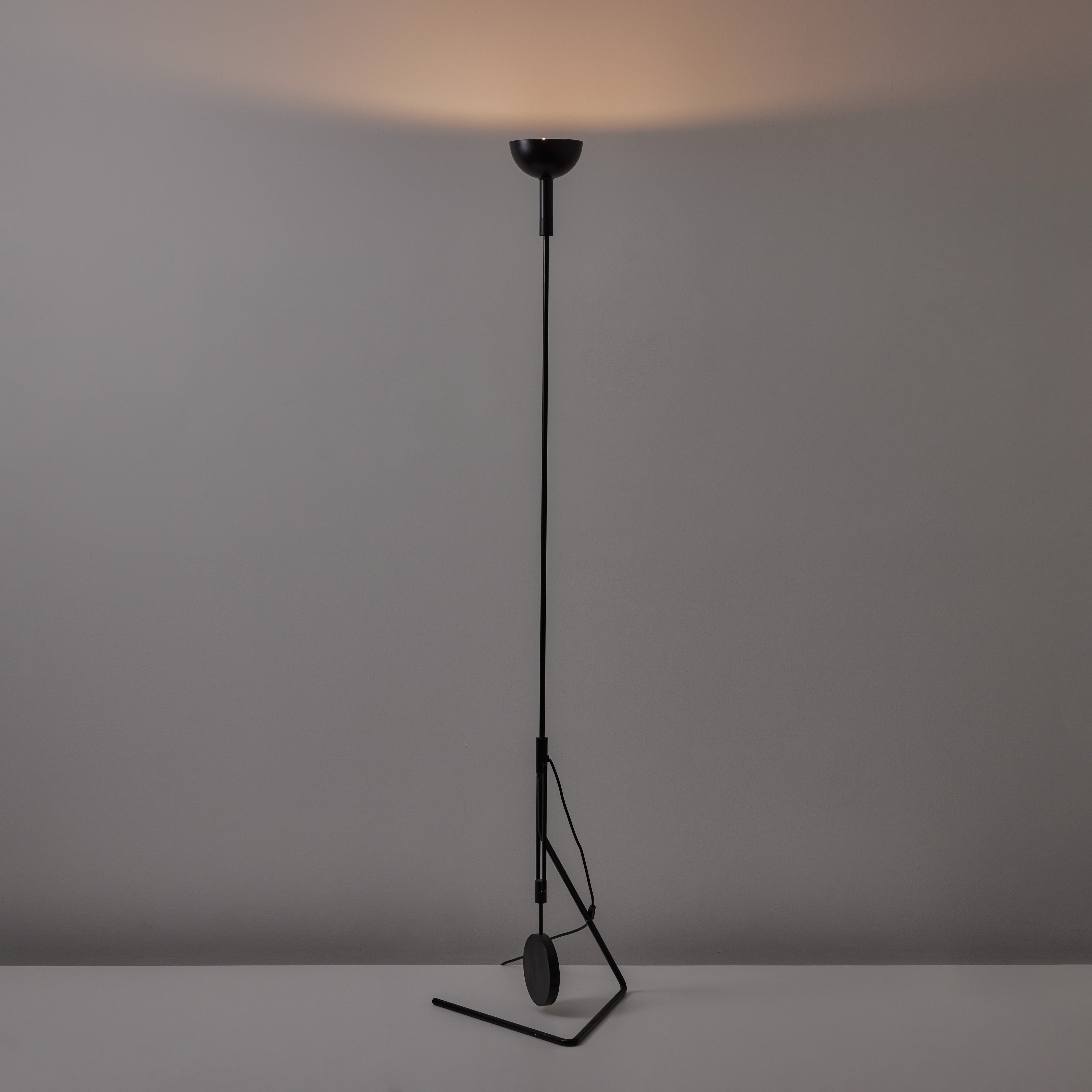 Floor Lamp by Martinelli Elio for Martinelli Luce. Designed in Italy, circa the 1970s. A slender all black uplight floor lamp. The light comes in two parts; one is the upper shade and hald body of the stem which rests on the bottom half by a
