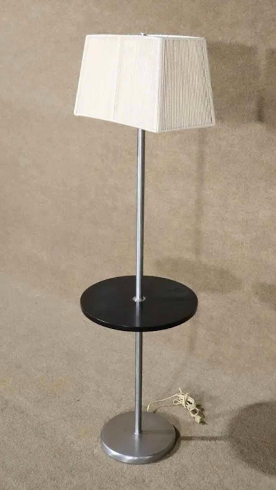 Mid-Century Modern style floor lamp with table. Chrome frame and wood table, designed by Nessen Studio.
Please confirm location.
