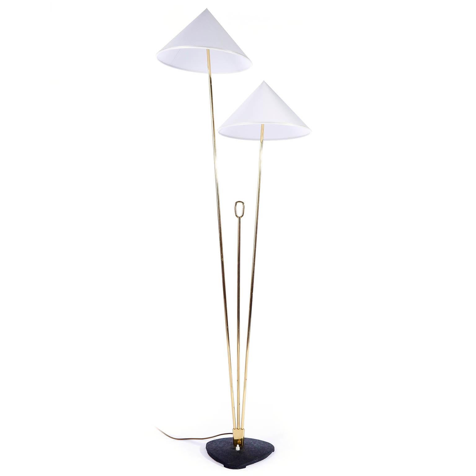 A brass floor lamp with cone shaped lampshades by Rupert Nikoll, Vienna, Austria, manufactured in midcentury, circa 1960 (late 1950s or early 1960s).
The stand is made of two brass rods in different lengths and in between is a shorter brass rod