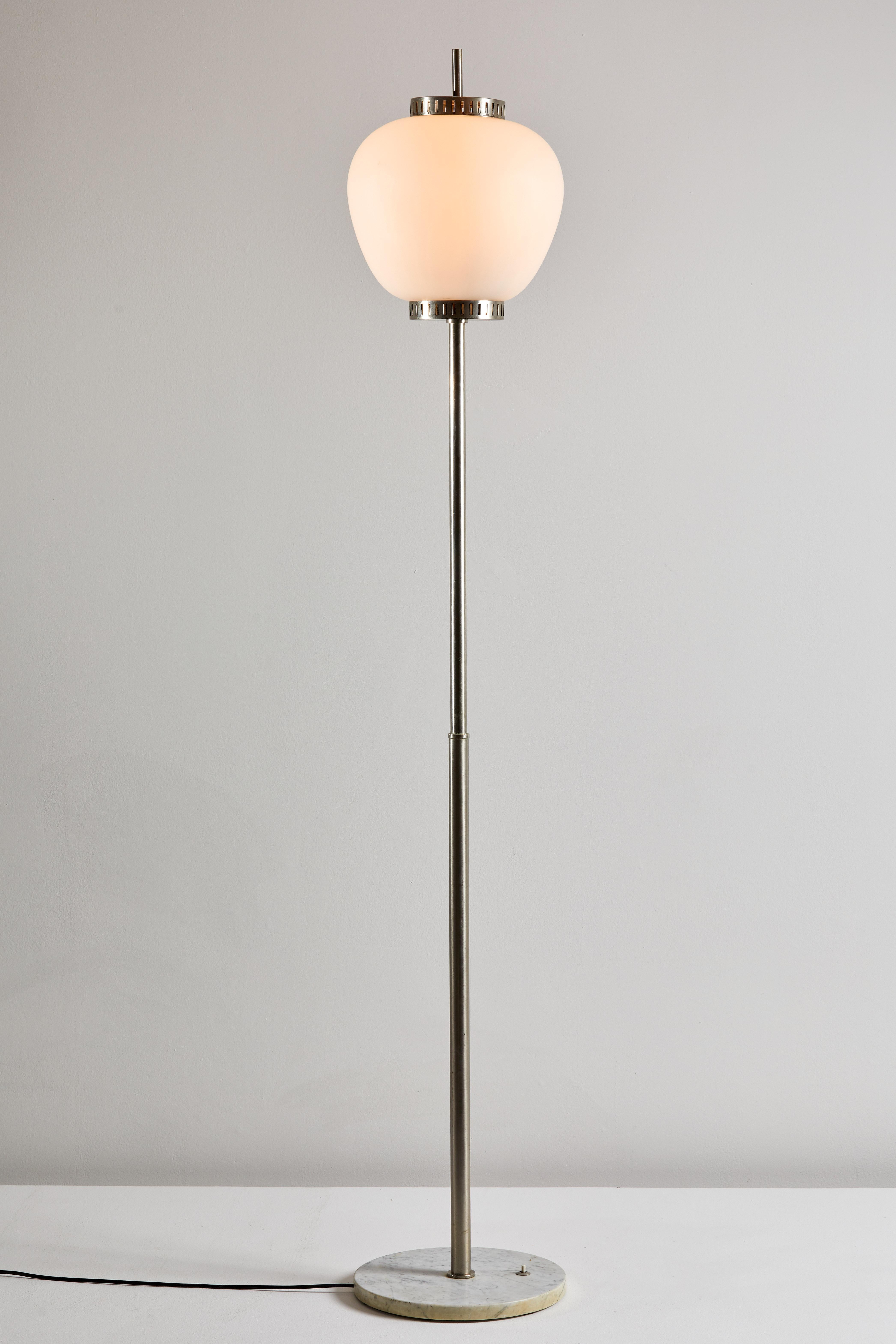 Floor lamp by Stilnovo. Manufactured in Italy, circa 1960s. Marble base, chrome-plated brass hardware, brushed satin glass diffuser. Rewired for U.S. sockets. On/off switch on base. Takes two E27 100w maximum bulbs. Bulbs provided as a onetime