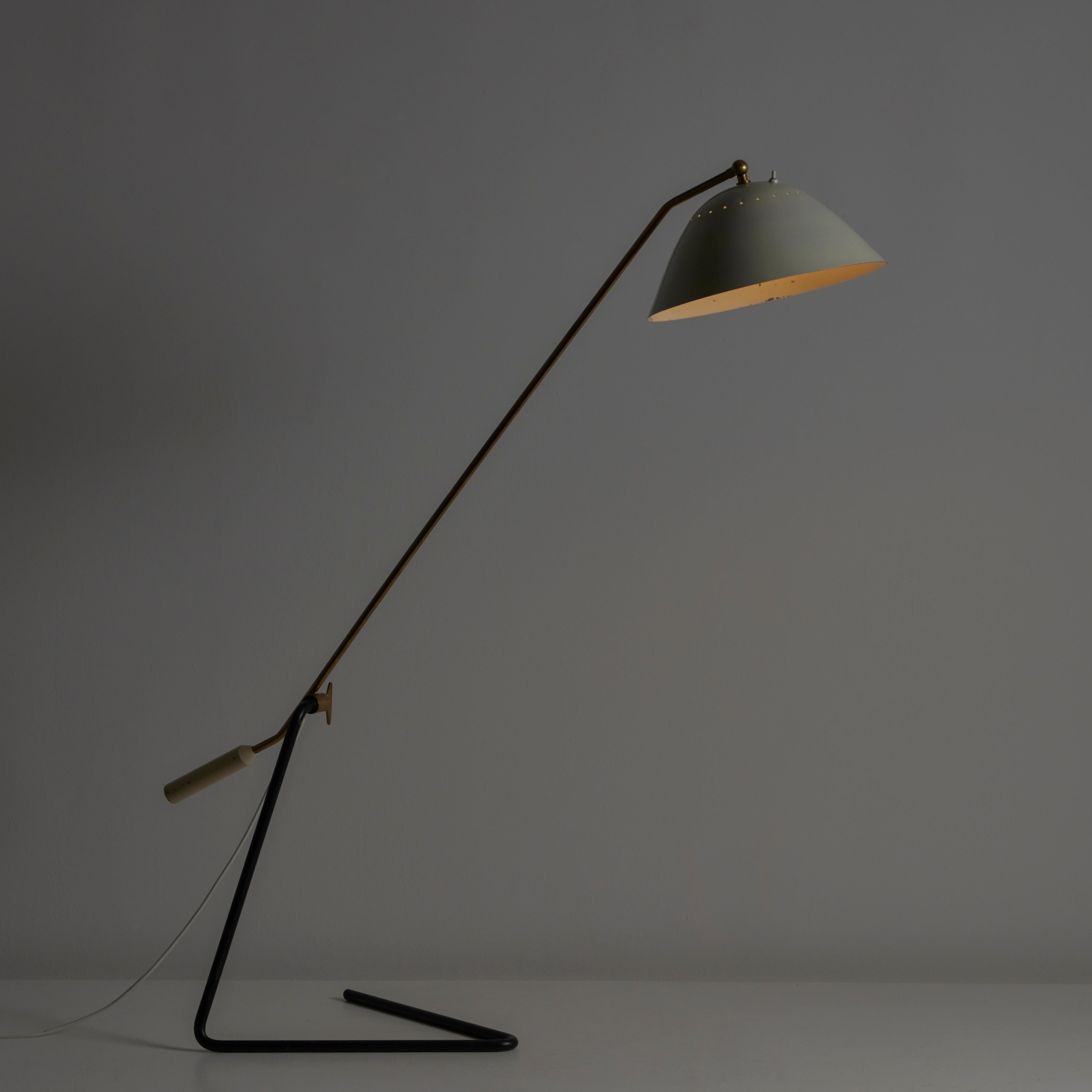 Floor Lamp by Stilnovo. Designed and manufactured in Italy, circa the 1960s. Adjustable cantilever floor lamp, with sectioned enamel finish, as well as a patinated polished brass stem. The shade features subtle perforation at the top to offer