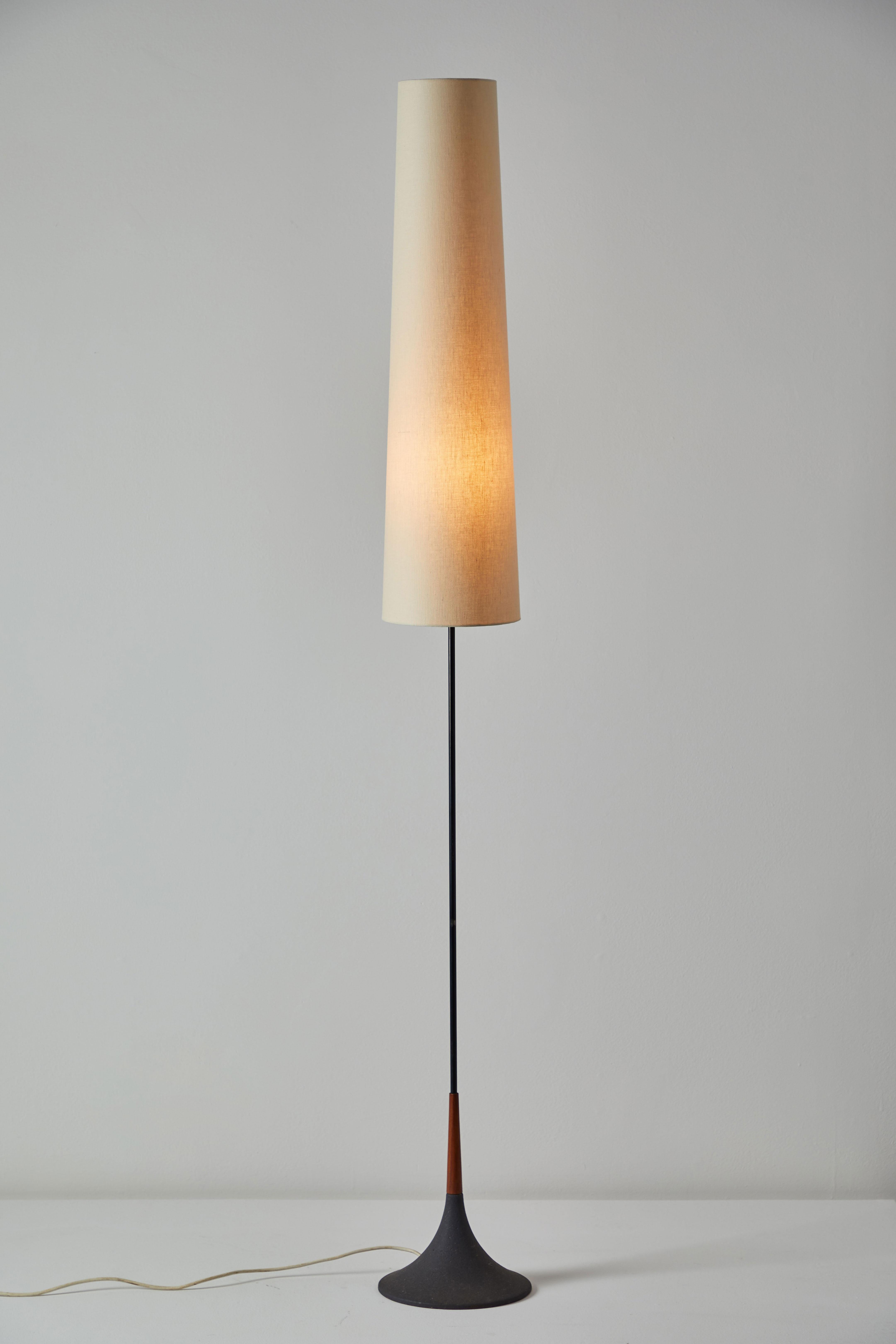 Floor lamp by Svend Aage Holm Sørensen. Designed and manufactured in Sweden, circa 1950s. Cast iron base, teak and black lacquered metal stem. Original cord. Custom fabricated linen shade. Takes one E27 60w maximum bulb.