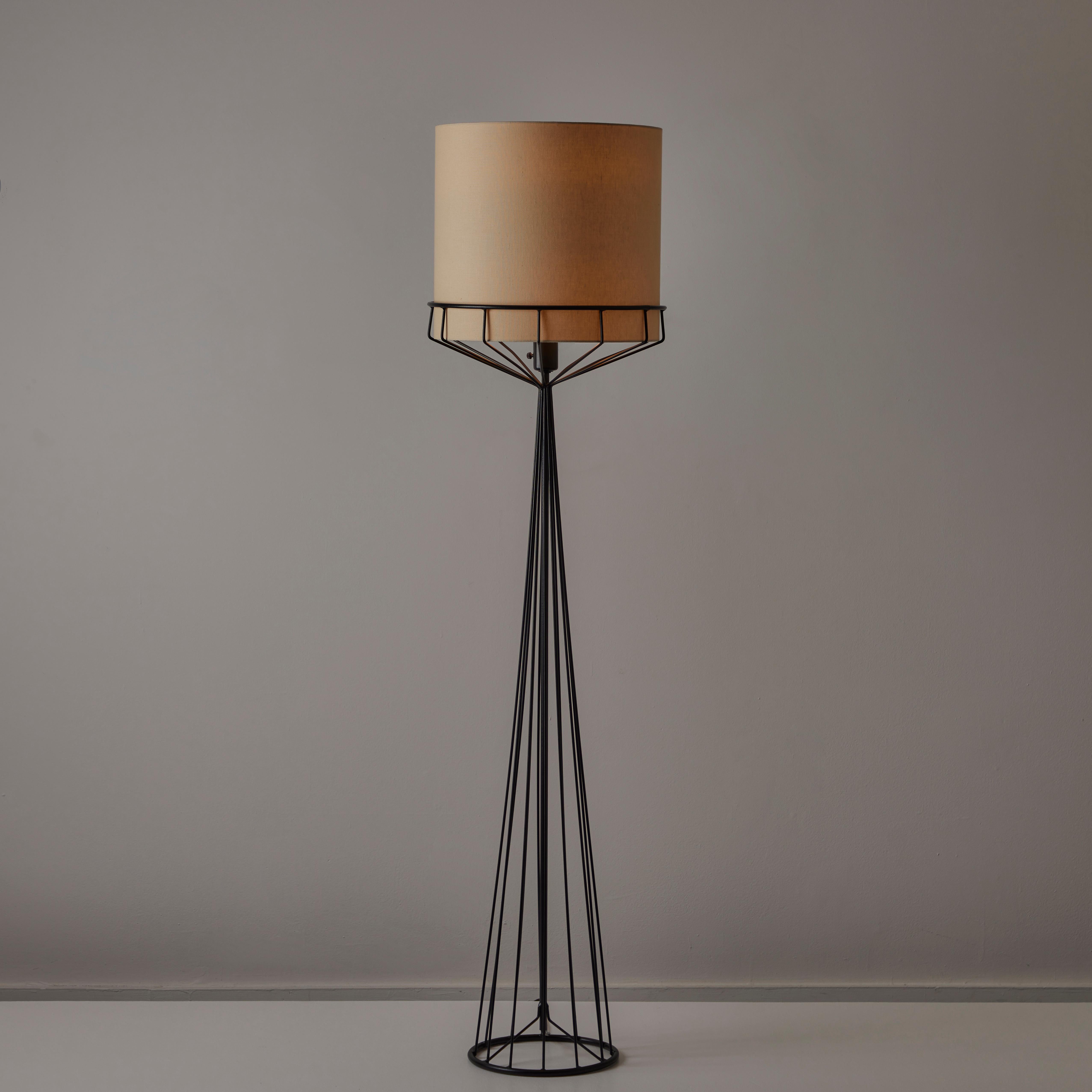 Floor Lamp by Tony Paul for The Elton Company. Designed and manufactured in the USA, in 1959. Multiple steel enameled rods form a cage-like floor lamp base. The top of the stand allows a shade to be nestled at the top. The lamp holds a single E26