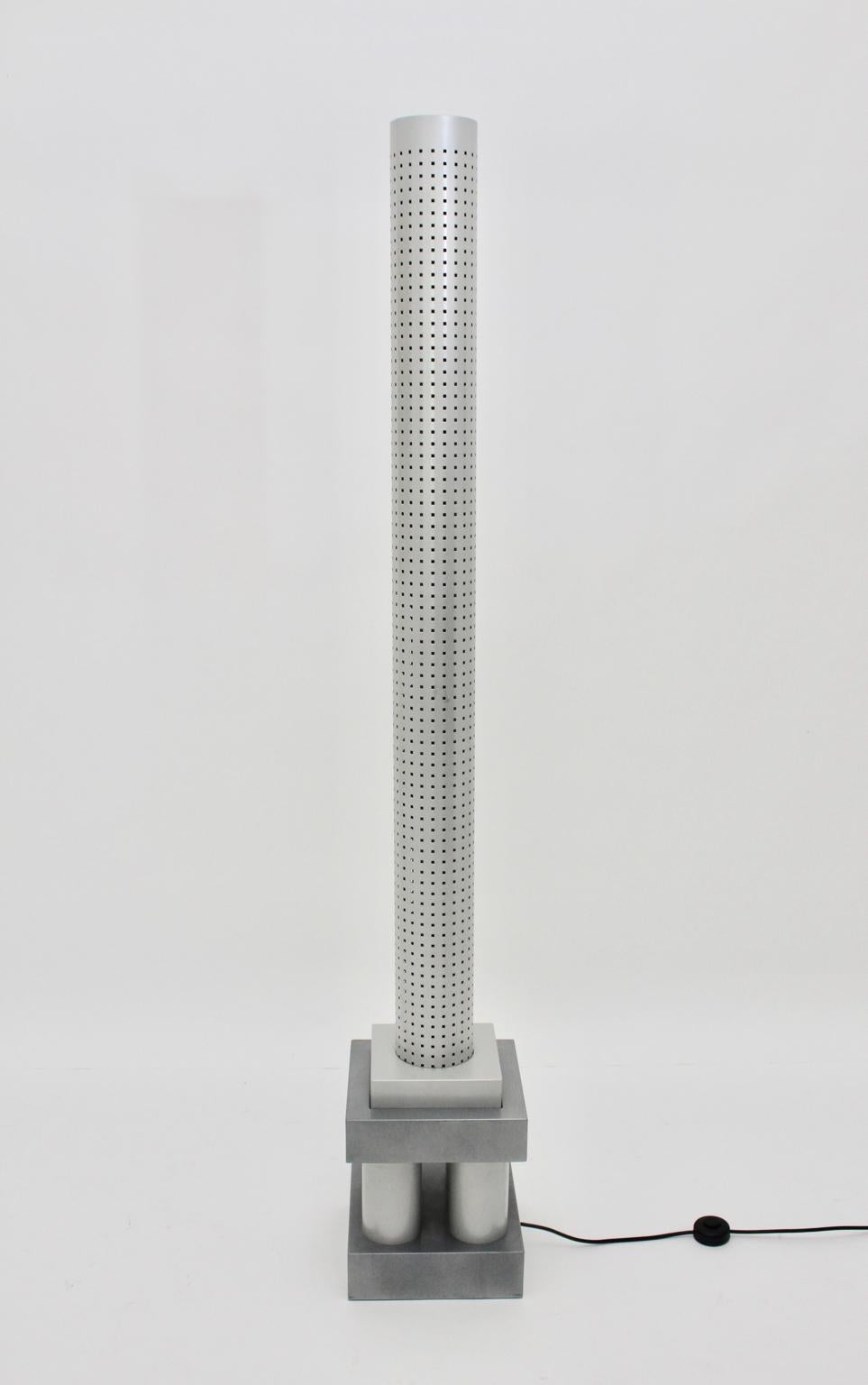 Modern sculptural floor lamp model Chicago Tribune designed by Matteo Thun 1985 for Bieffeplast Padua, Italy.
The floor lamp consists of grey and silver enameled metal and a perforated shade.
Three neon tubes illuminate this floor lamp.
The