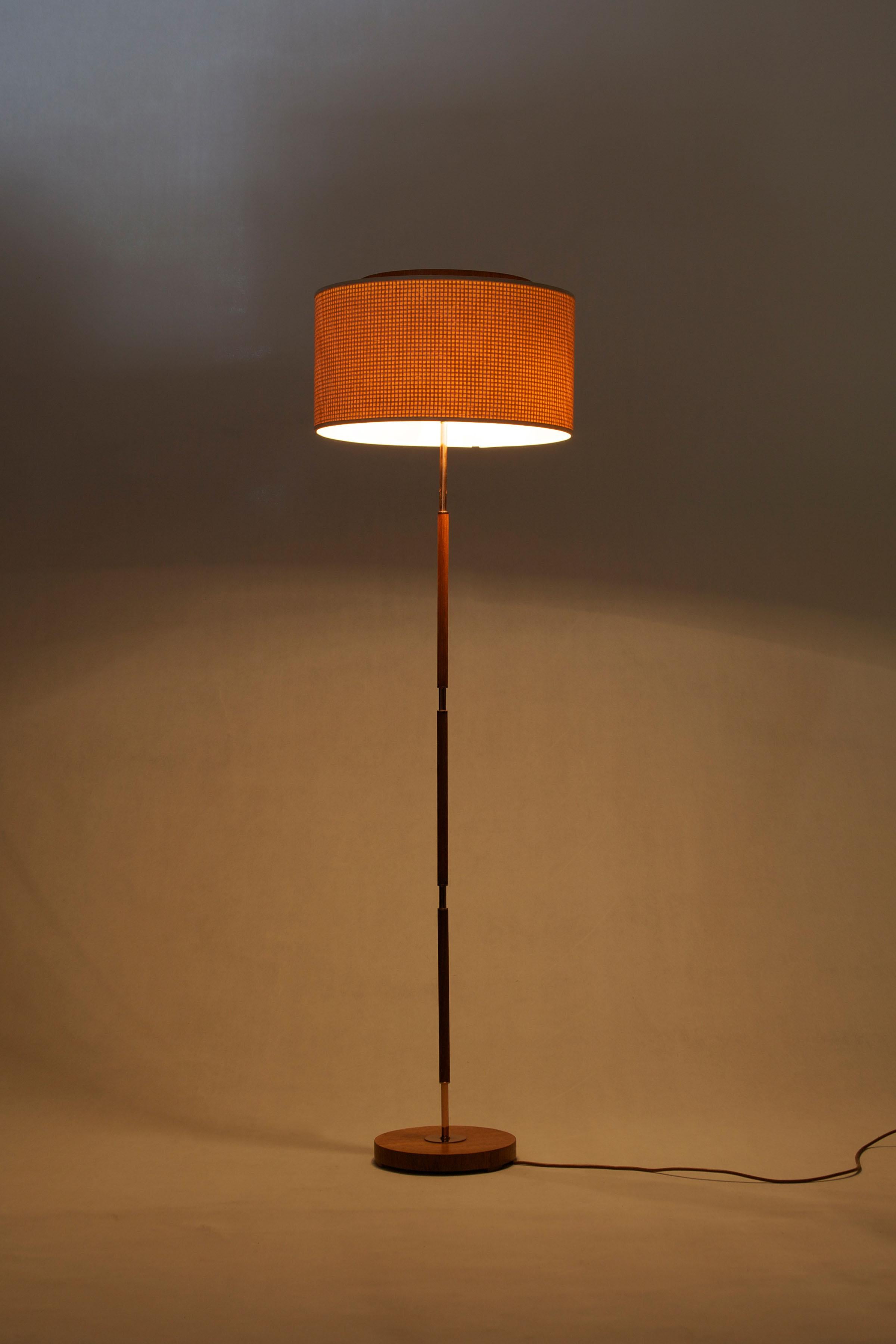 Floor lamp design and manufacturing by Temde, Germany, 1960s. The Lamp is made out of teak and copper and has a fabric shade.