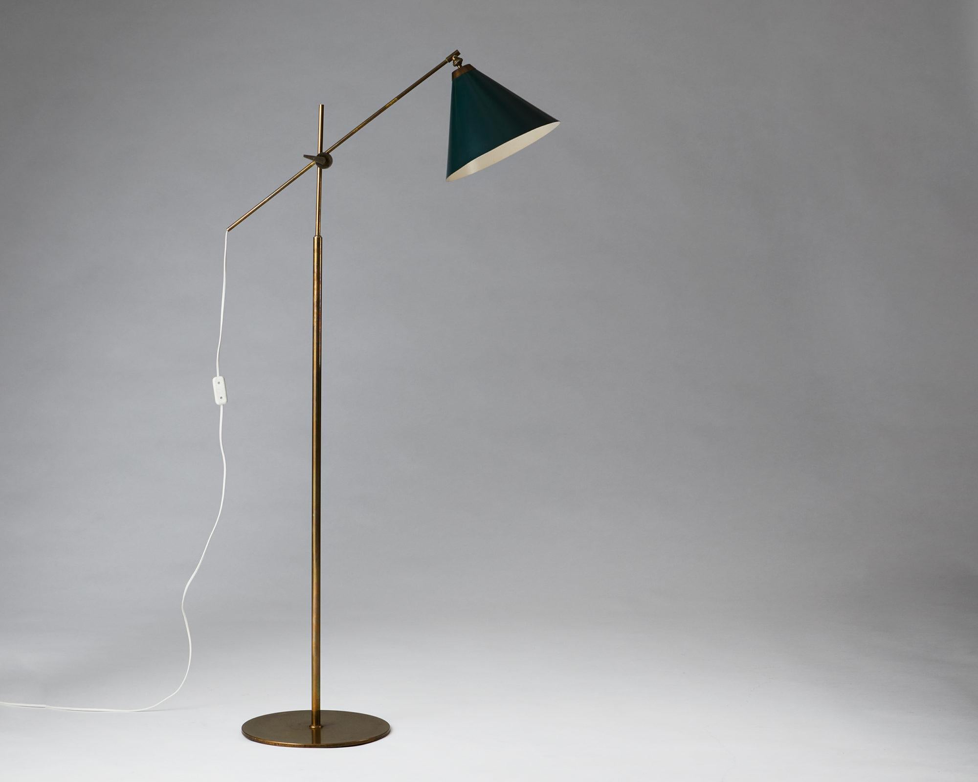 Painted brass with green lacquered metal shade.

Height is adjustable.

Measures: H 148 cm / 4' 10 1/4