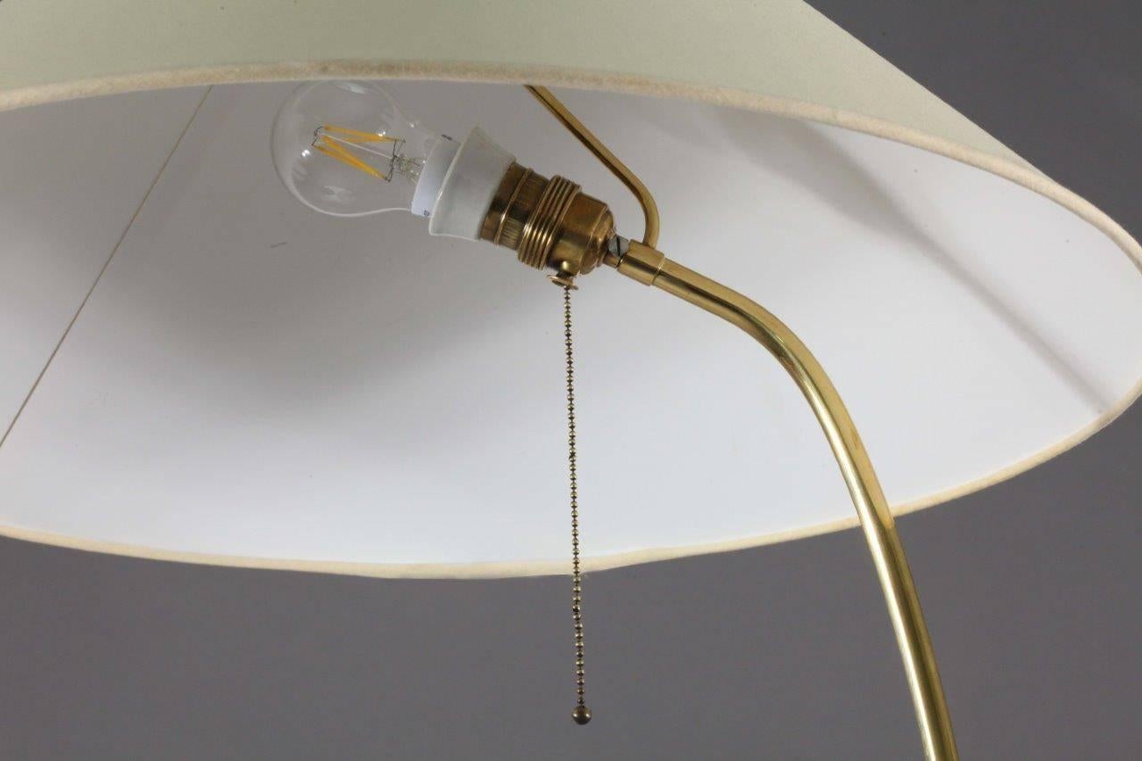 Floor lamp.
Rupert Nikoll,
Vienna 1950.
brass base, leather grip, fabric shade