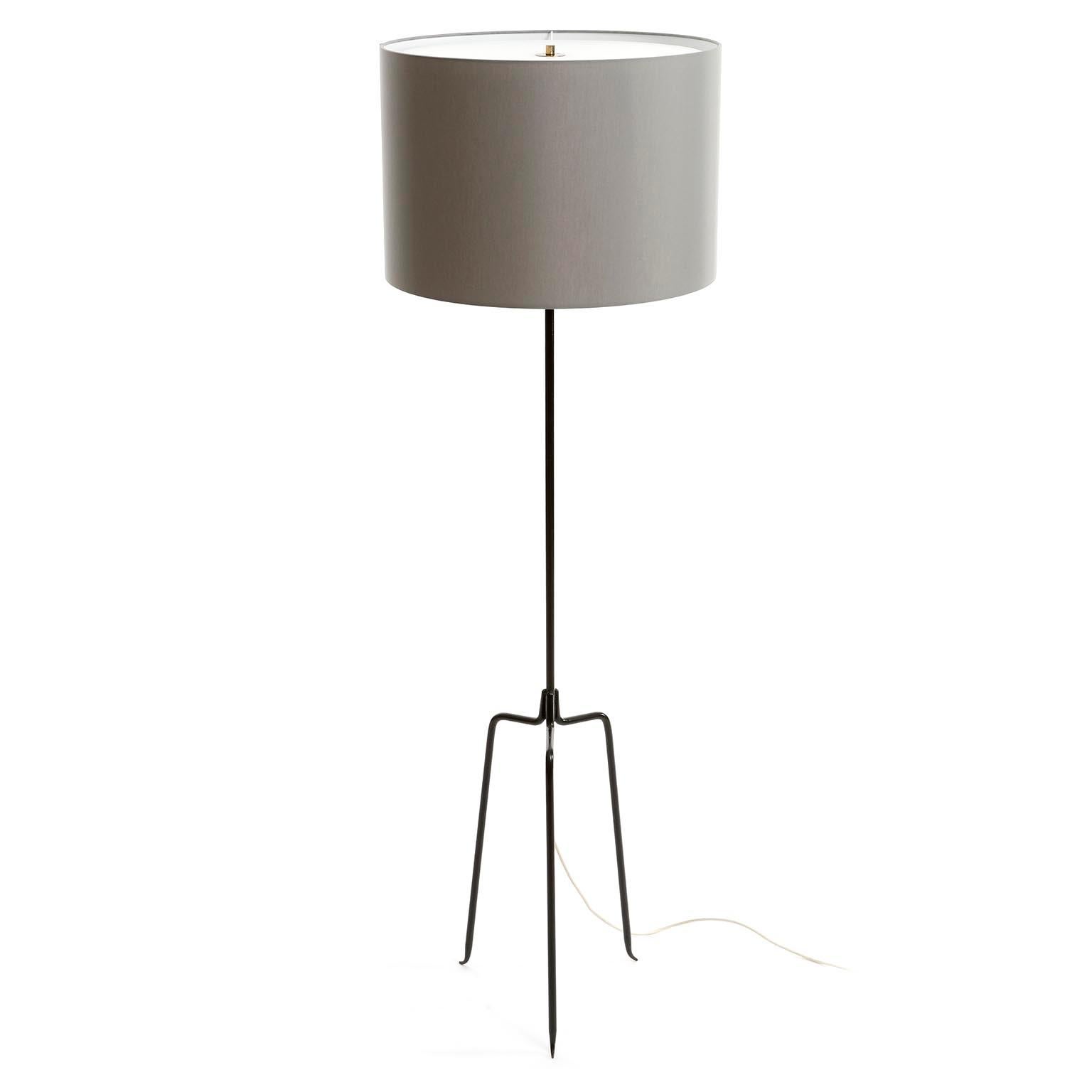 A Mid-Century Modern floor lamp model 'Eisendreistelz' model no. 2061 by J.T. Kalmar, Vienna, Austria, manufactured ca. 1960 (late 1950s or early 1960s).
The light is made of a blackened iron tripod stand, brass and a grey shade.
The shade is