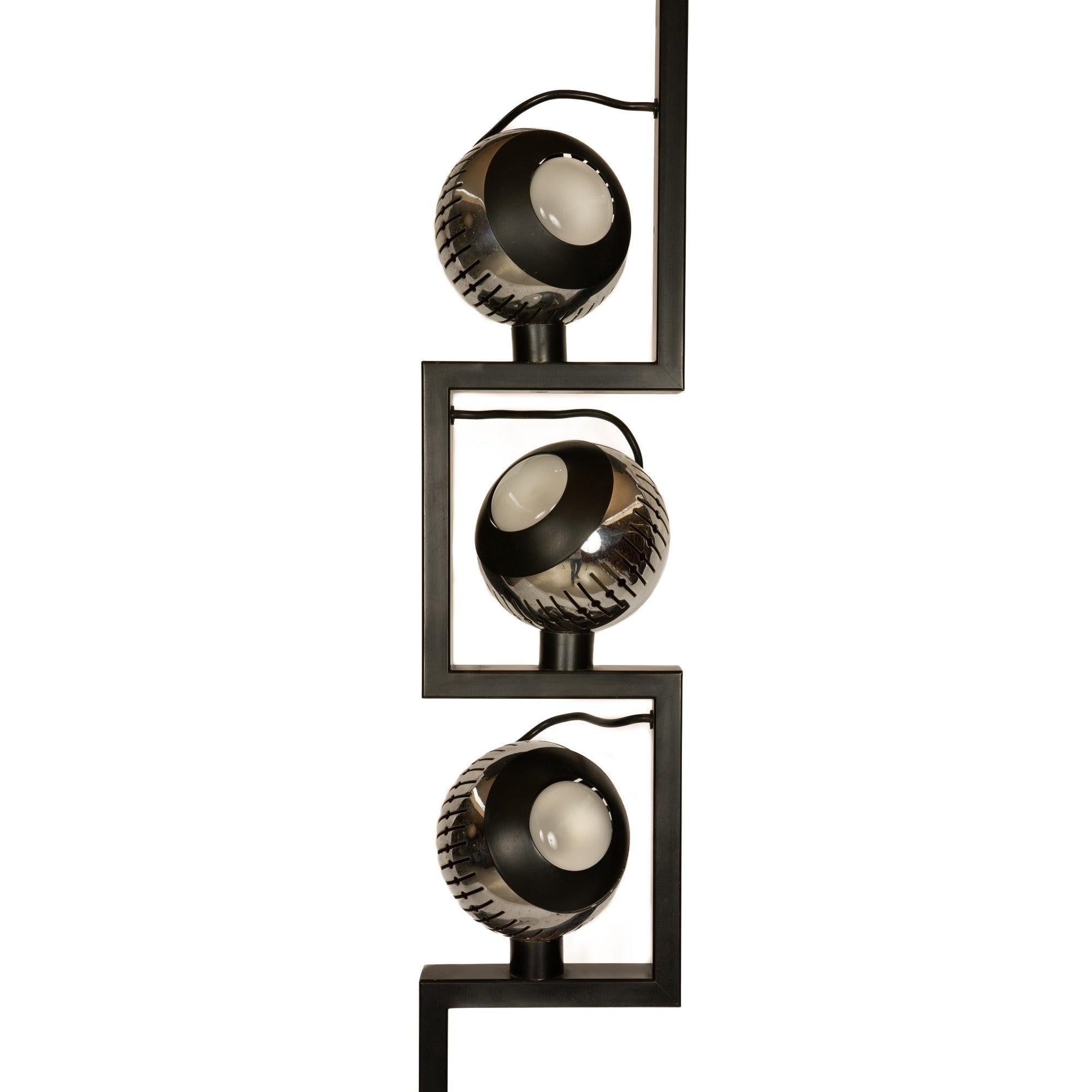 A floor lamp with three magnetic diffusers on a marble base.