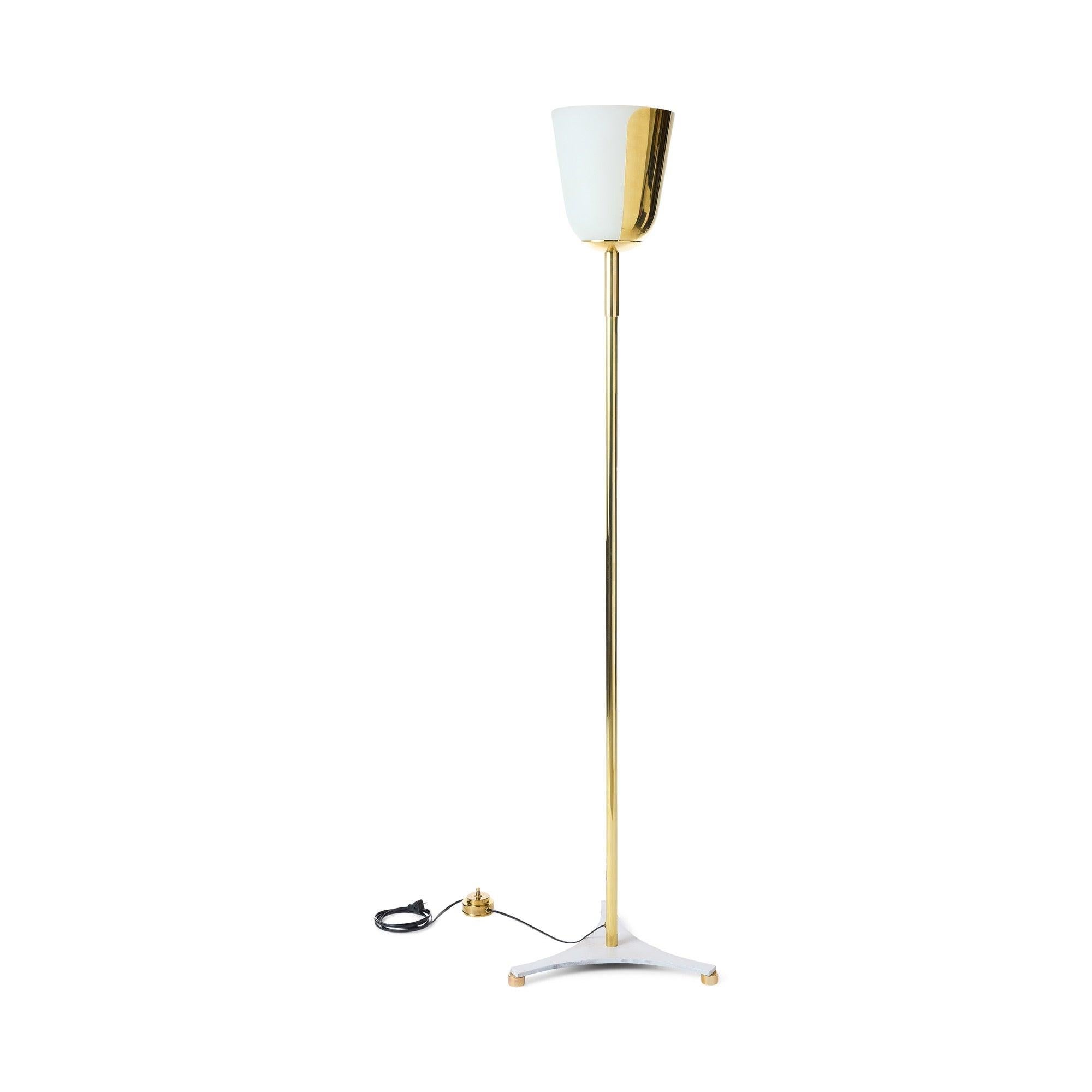 Metal torchere of satin finished chrome consisting of a vase shaped shade with a thick, satin frosted glass insert open at the top with its sides half shielded by a metal cover and half able to emit light. The shade is attached to an unadorned