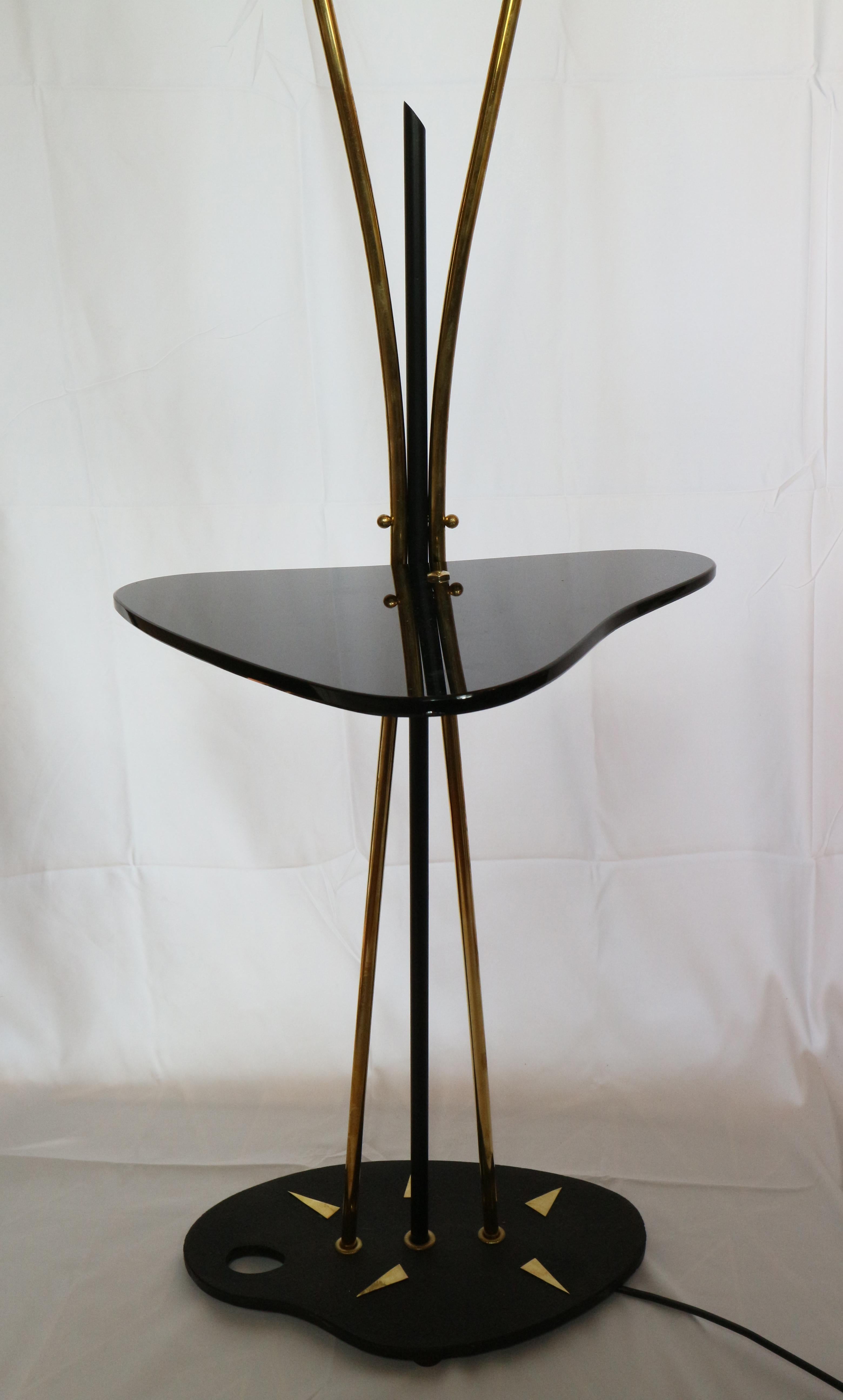 Decorative 1950's circa two head french brass floor lamp with a black glass detail.

We remain at your complete disposal for any other needs.

Lustri -
Italy