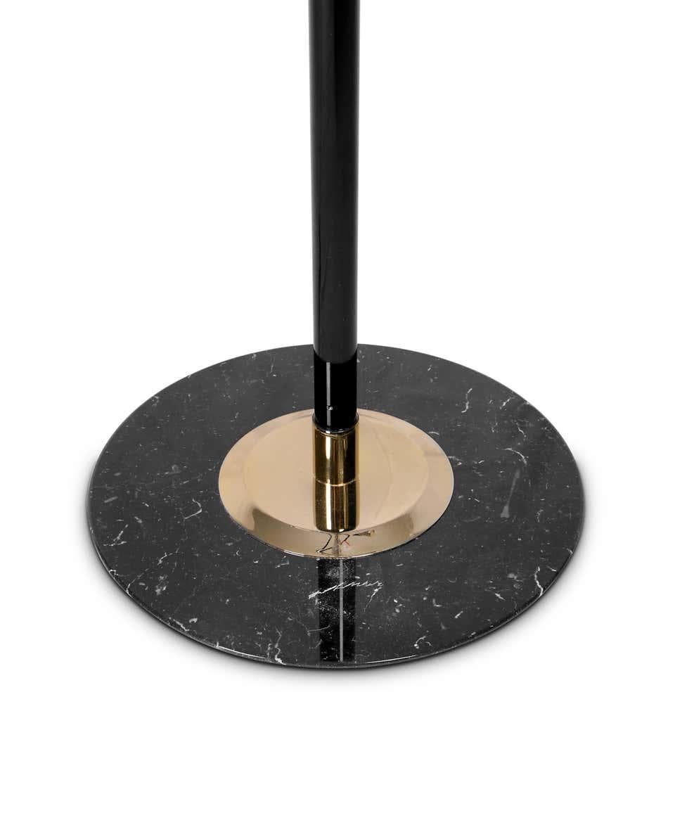 Floor lamp in black and brass.

Estimated production time: 6-7 weeks

9x G9 bulbs (included) (for USA not included) max 40W per bulb.

Each cone lamp shade is conducted by a brass arm and its counter-weight. The matte black shades drape on the