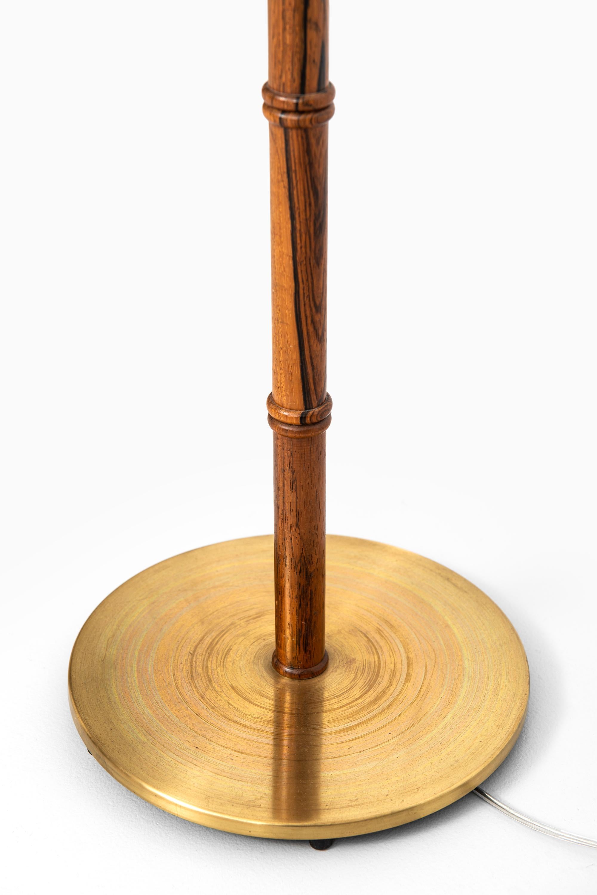 Rare floor lamp in rosewood and brass. Produced by Falkenbergs Belysning in Sweden. Please not: We’re selling this lamp without any lamp shade.