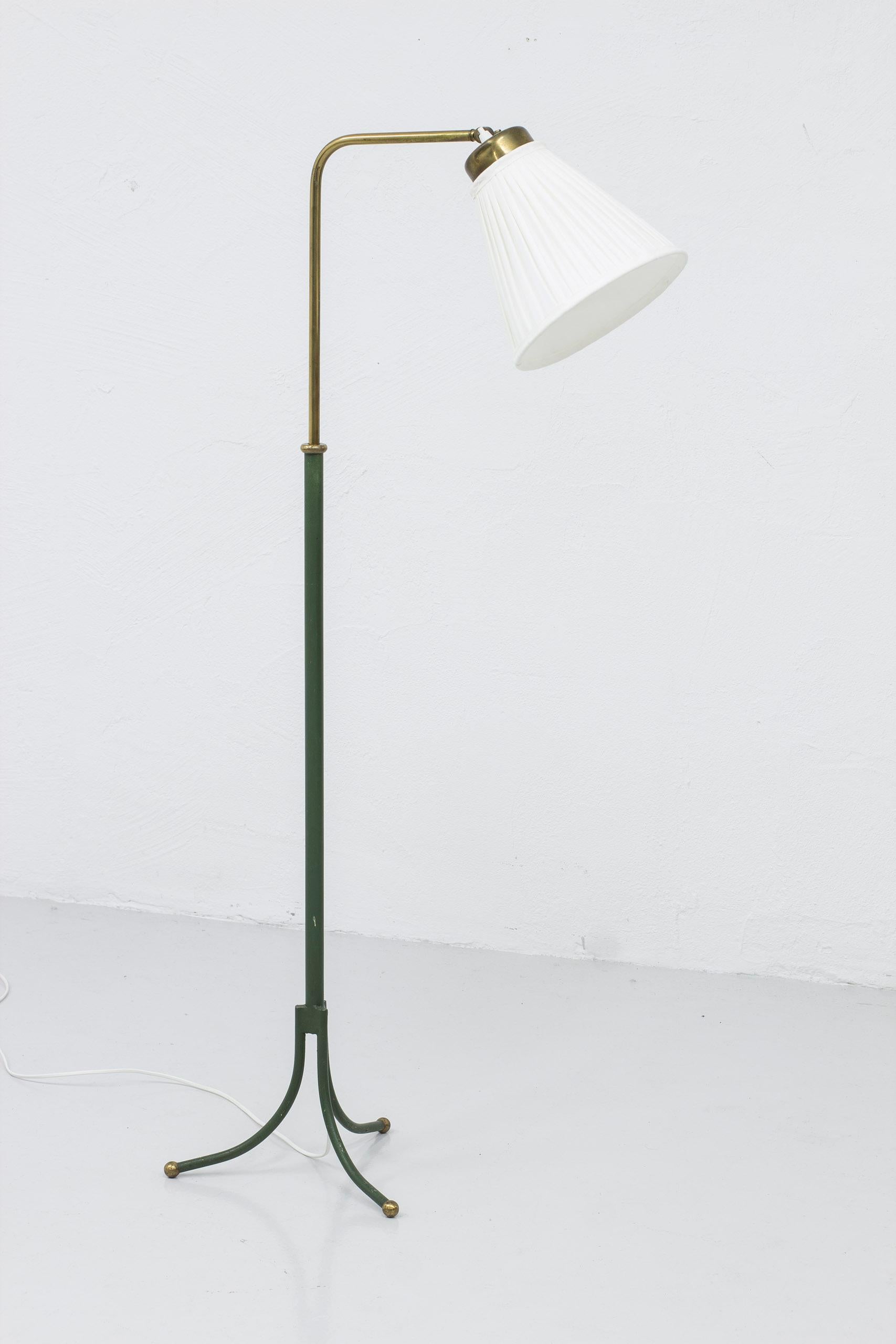Early floor lamp designed by Josef Frank. Model 1842 designed in the 1930s. This piece produced by Svenskt Tenn during the 1940s. Original green lacquer and brass. New hand sewn pleated lamp shade. Light switch on the top of the lamp in working