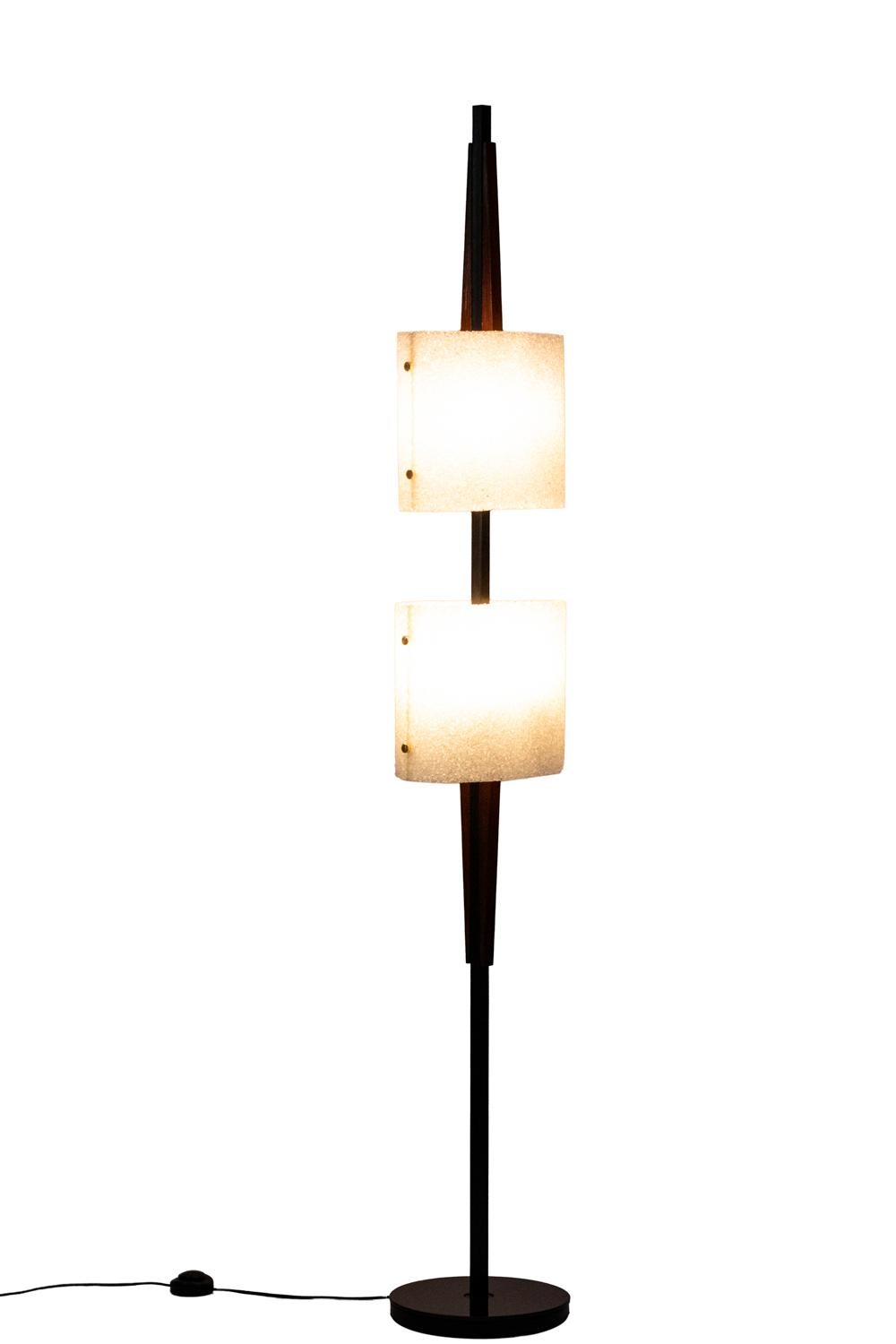 Floor lamp in granite resin and wood with two lights. Navette shape wood and black lacquered metal shaft on which are hung two oval lampshades. Circular wood base.

Work realized in the 1950s.

New and functional electrical system.