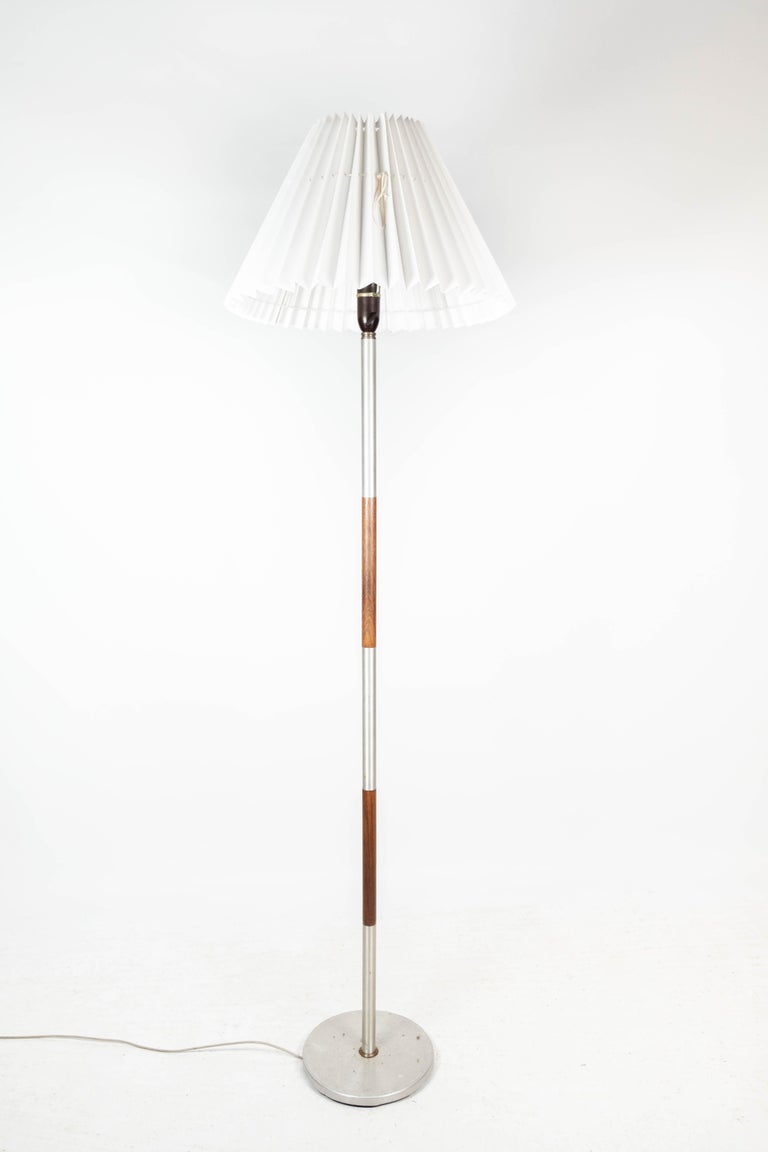 Floor lamp in rosewood and metal, of Danish design from the 1960s. When buying this lamp, a hand made white shade of Danish design is included in the price. The lamp is in great vintage condition.