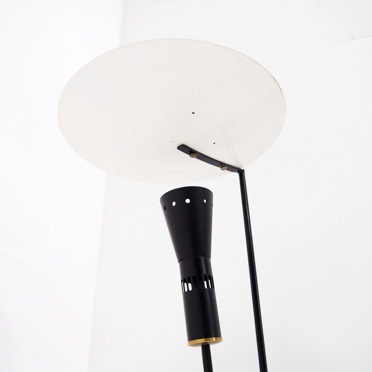 Floor lamp in the style of the ‘B211’ floor lamp by Michel Buffet.

This lamp is probably made in the 1970s or 1980s and in very good condition. It’s made of a metal base and reflector, with a hard plastic uplighter. The designer and manufacturer