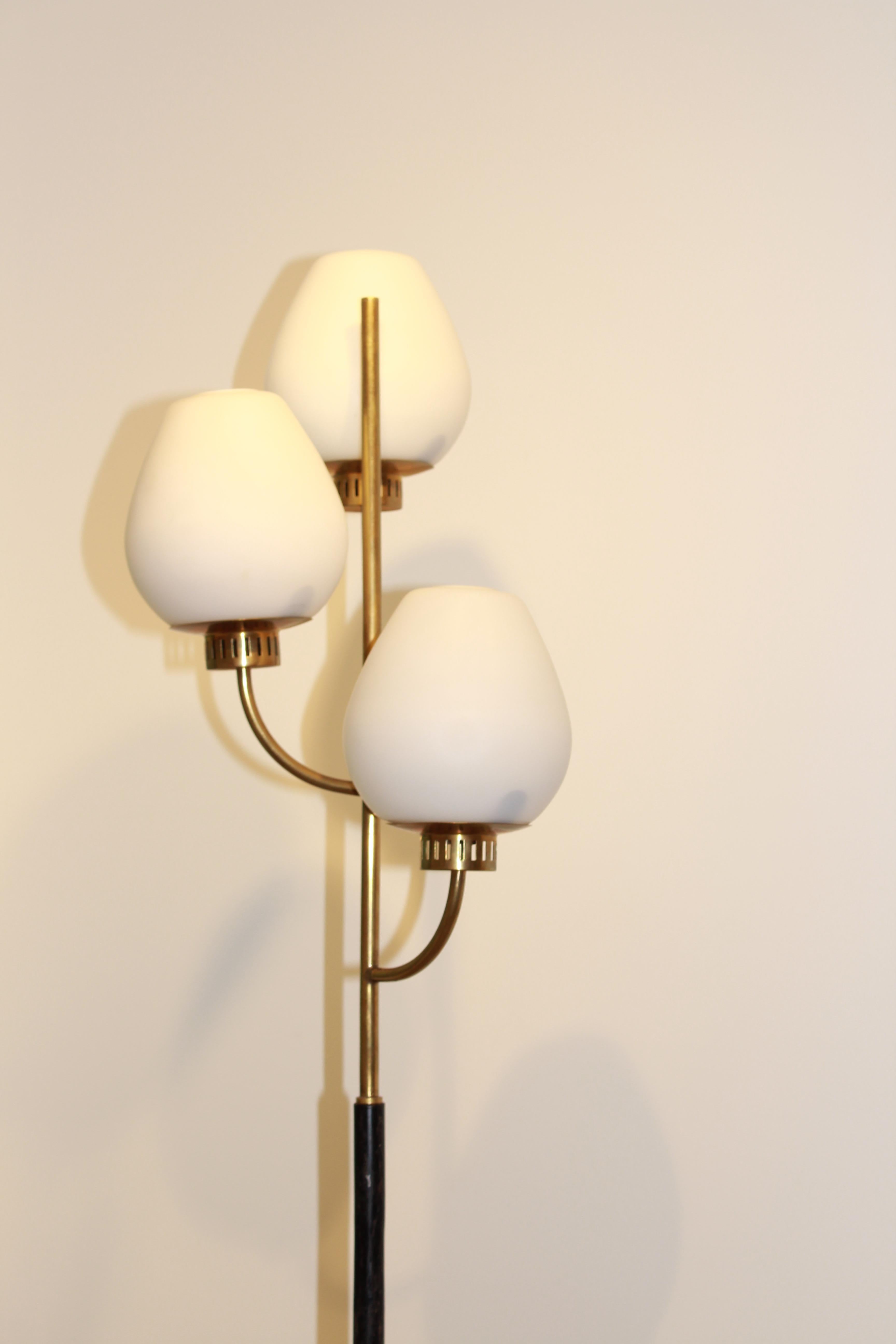A floor lamp, 1950s. Marble, varnished tubular steel, brass, and frosted opaline glass.