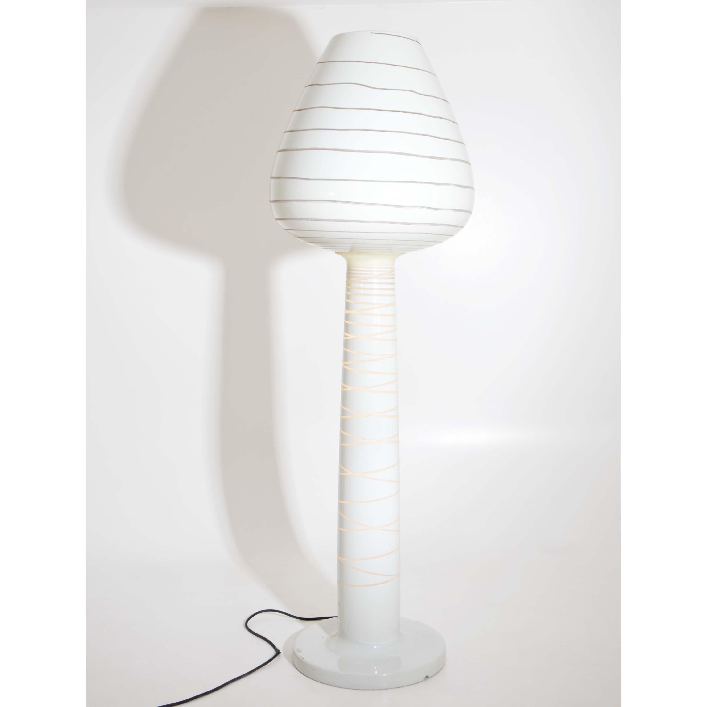 Large cream white polyethylene floor lamp in tulip shape. The translucent, spirally arranged line wraps around the entire foot and head and creates a special light effect. Embossed on the base 