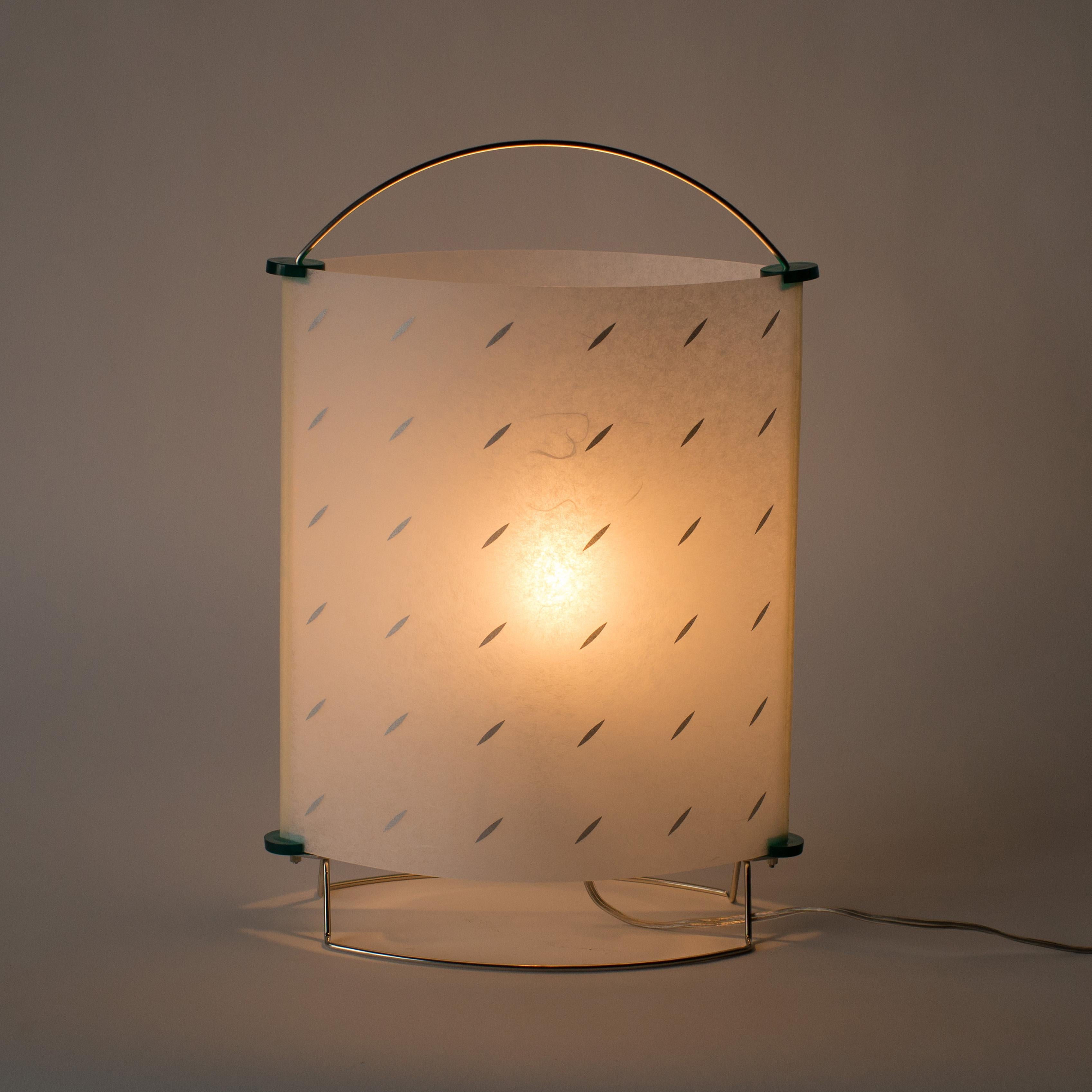 Floor or table lamp deigned by Masanori Umeda.
This lighting consists of stainless frame and plastic covered washi Japanese paper shade. Shade has original washi texture.