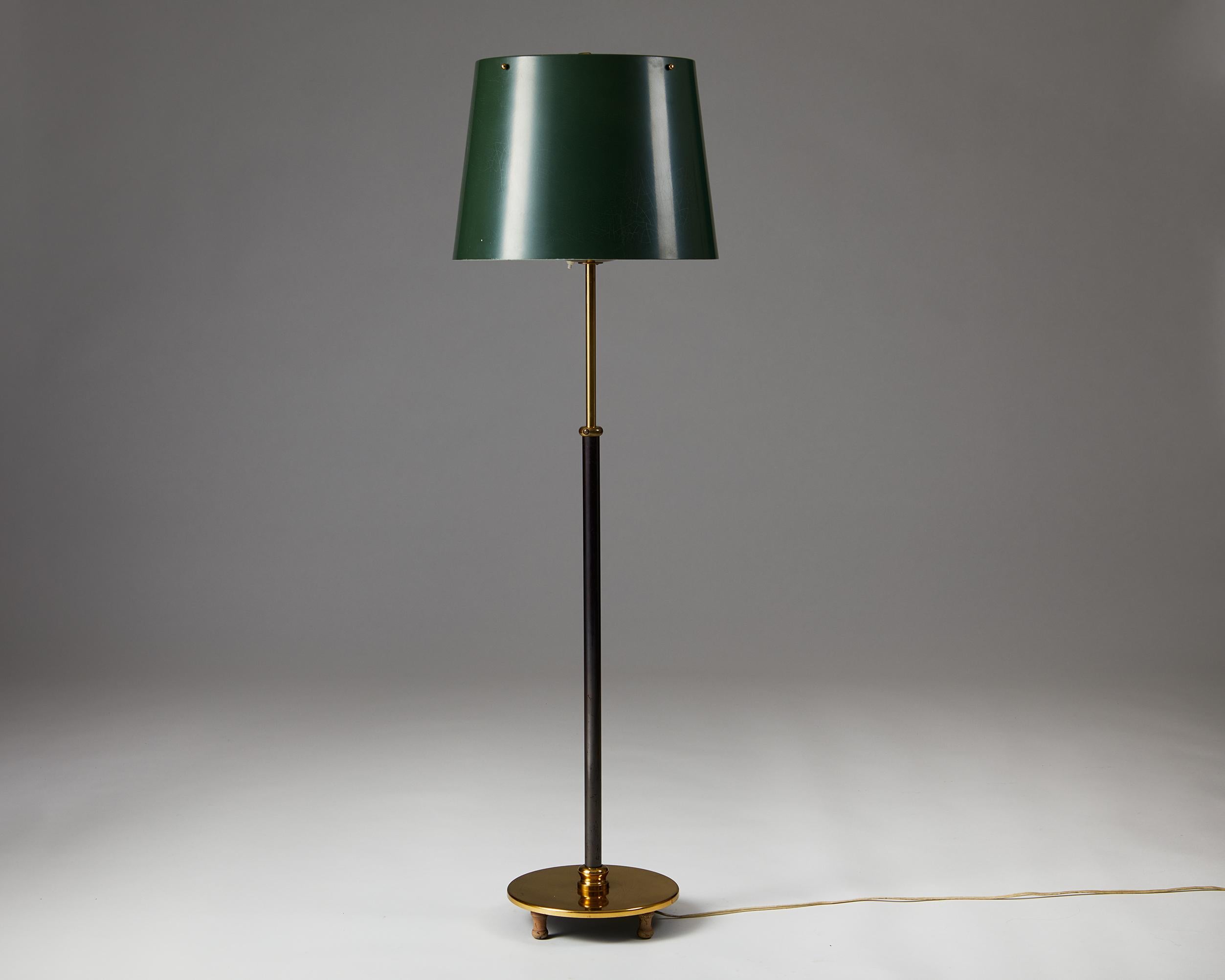 Black lacquered brass with metal shade.

The height is adjustable.

Measure: H: 141 cm / 4' 7 1/2