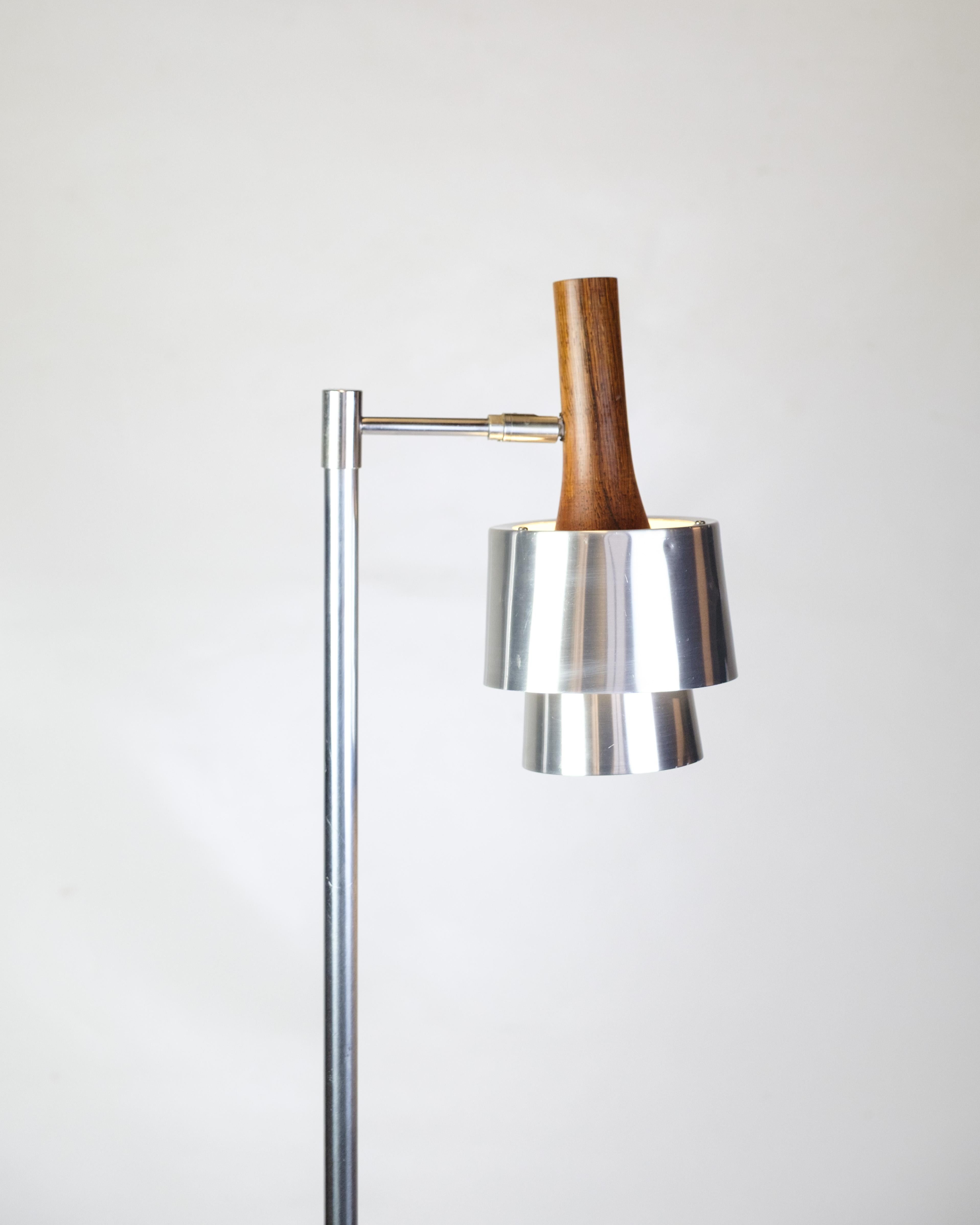 Floor lamp, model 294, designed by Jo Hammerborg for Fog & Mørup in the 1960s. The lamp is made of brushed steel with rosewood details and has a cylindrical shade mounted on a slim, three-legged frame. The shade can be tilted for flexible light