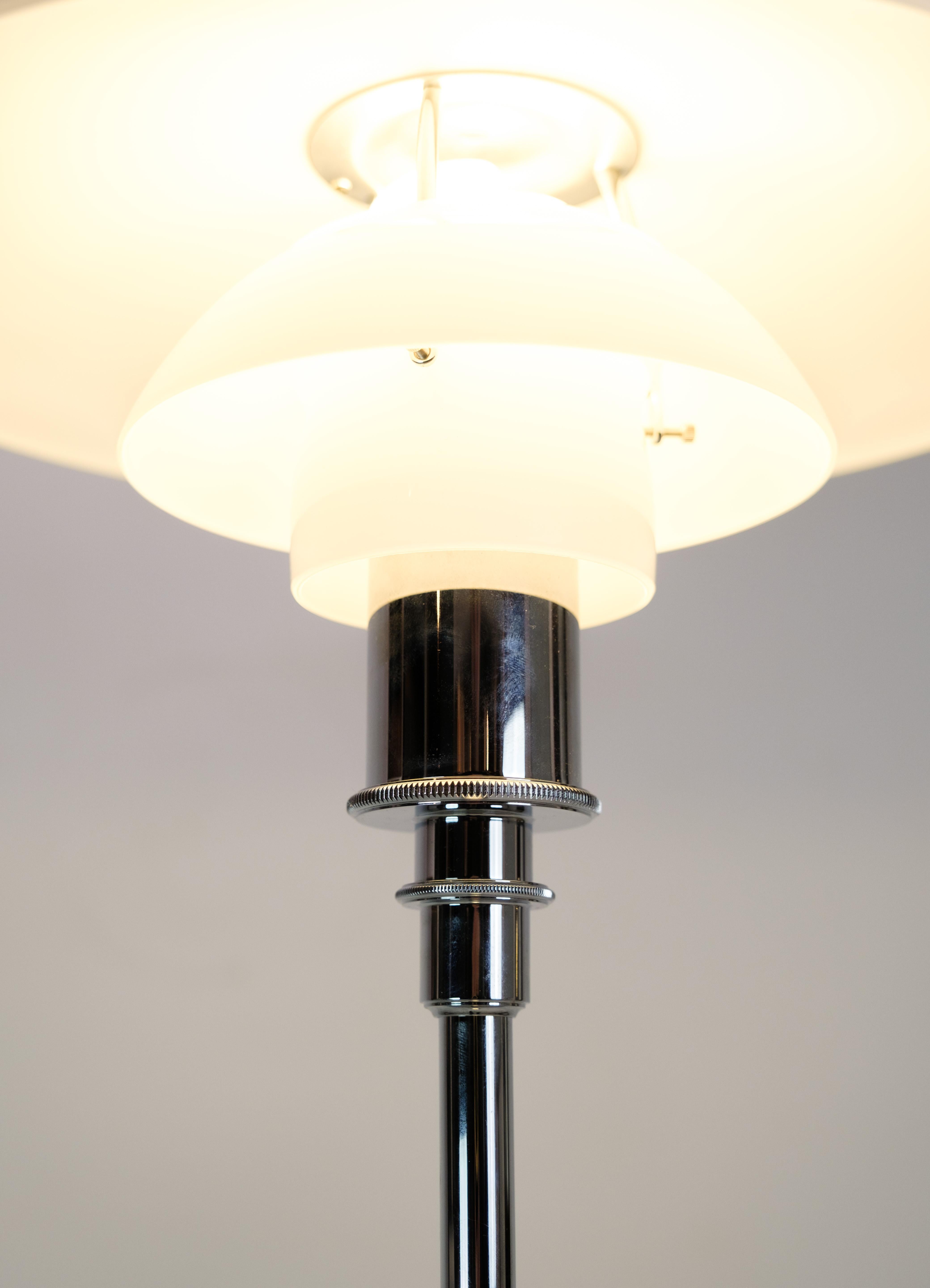 Floor lamp, Model 3½-2½ chrome, designed by Poul Henningsen with white opal glass shades made by Louis Poulsen. The frame is high-gloss chrome-plated with a black plastic cord with plug.

This product will be inspected thoroughly at our