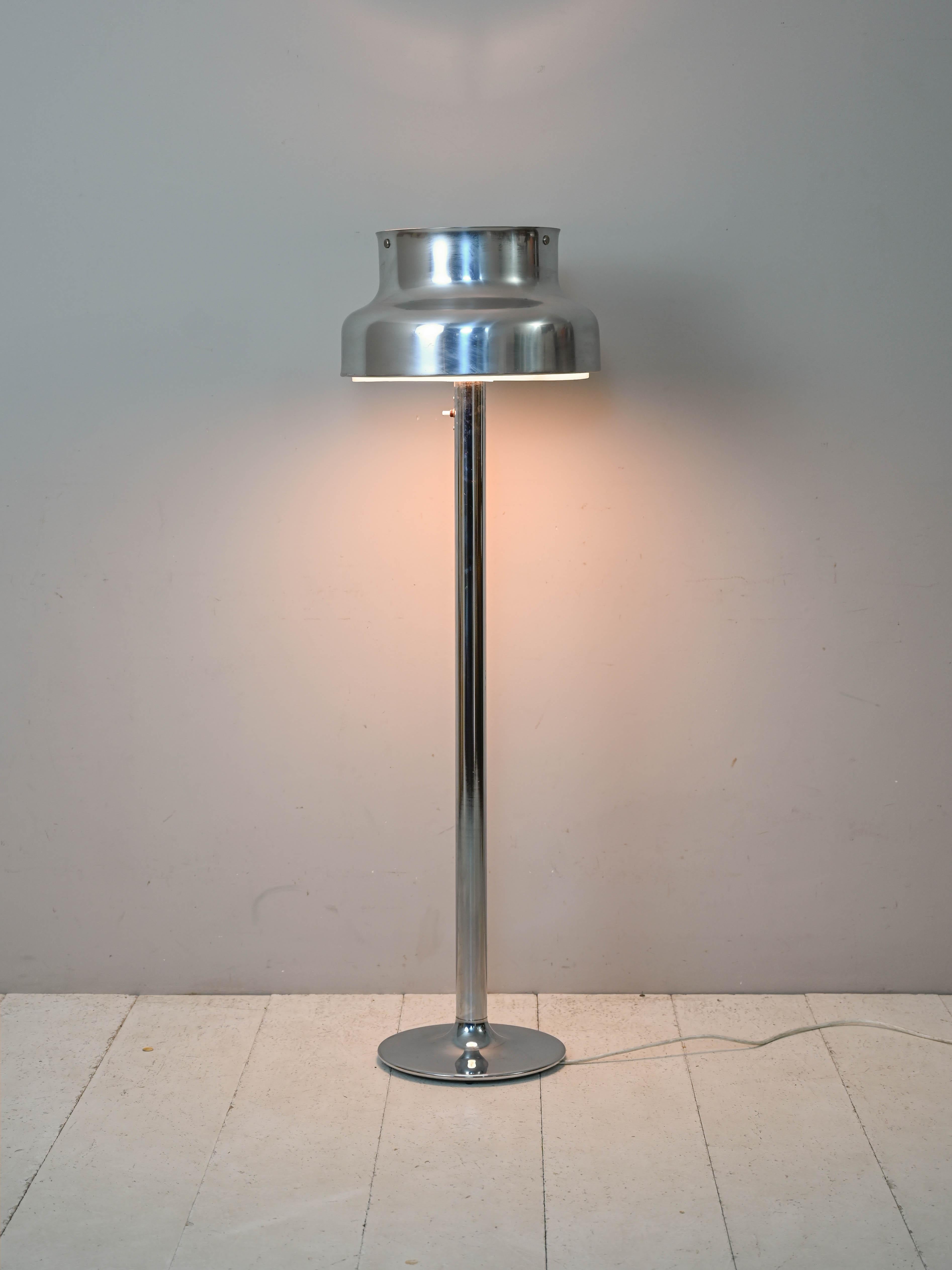 Floor lamp designed in 1968 for Ateljé Lyktan, Sweden.

This floor-standing version of the famous Bumling icon is striking in its silver color. 
Known for the shape of the lampshade with modern lines that are still absolutely current, it features