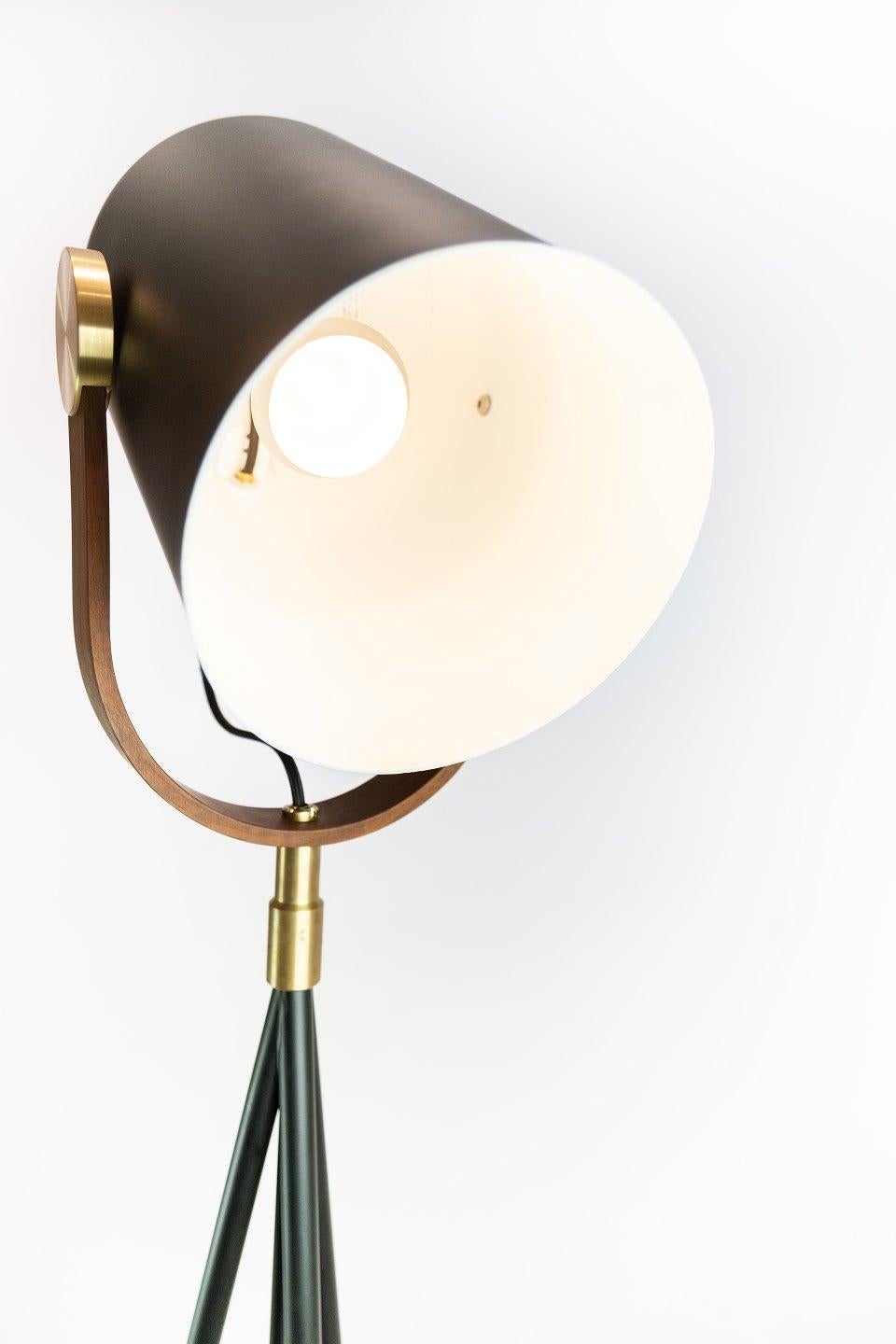 Floor lamp, model Carronade, by Le Klint. The lamp is of black metal and teak.
 