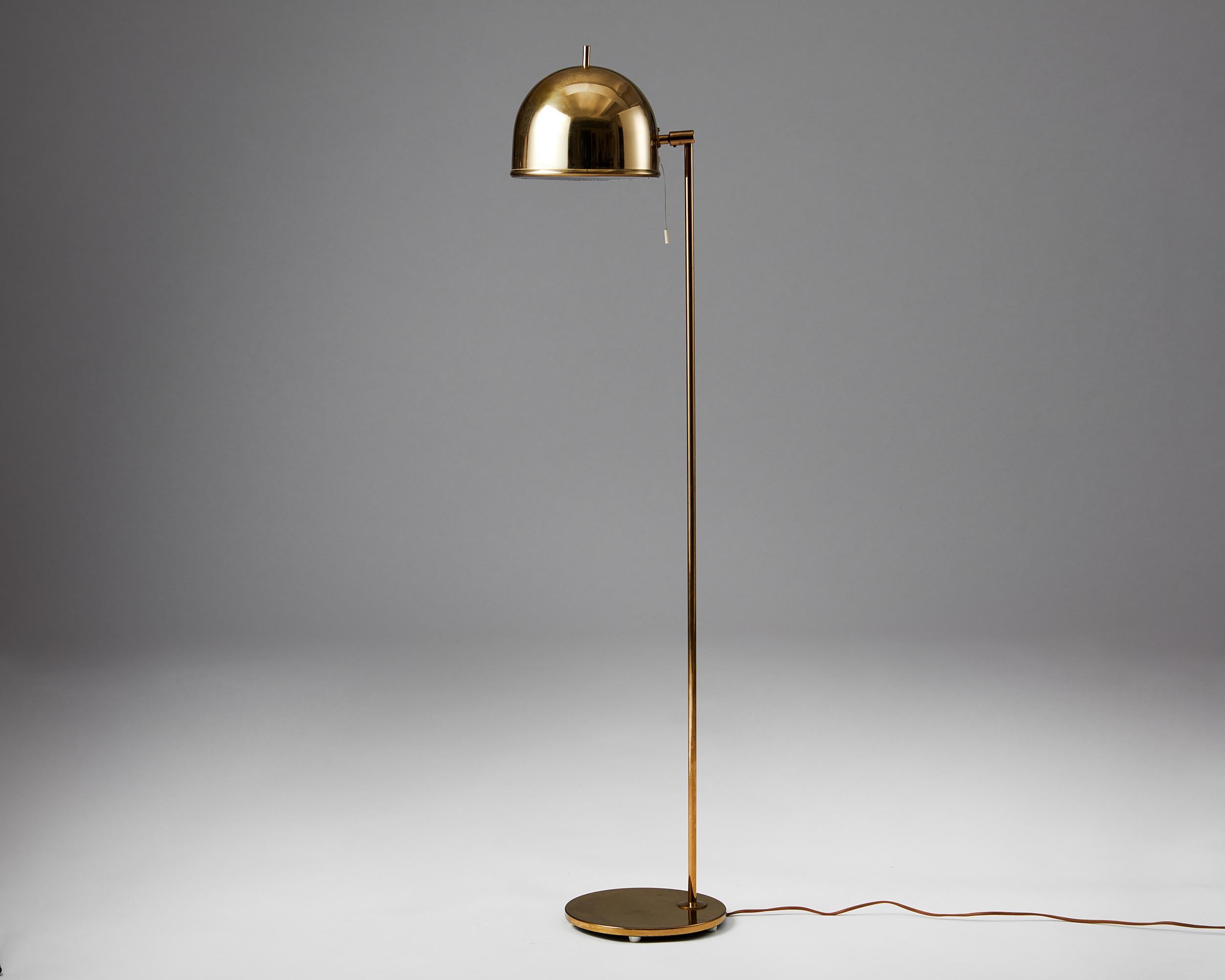 Floor lamp model G-075 designed by Eje Ahlgren for Bergboms,
Sweden. 1960s.
Brass.

This floor lamp with fully adjustable shade was manufactured in brass by Bergboms and designed by Eje Ahlgren. The protruding brass rod at the top of the shade