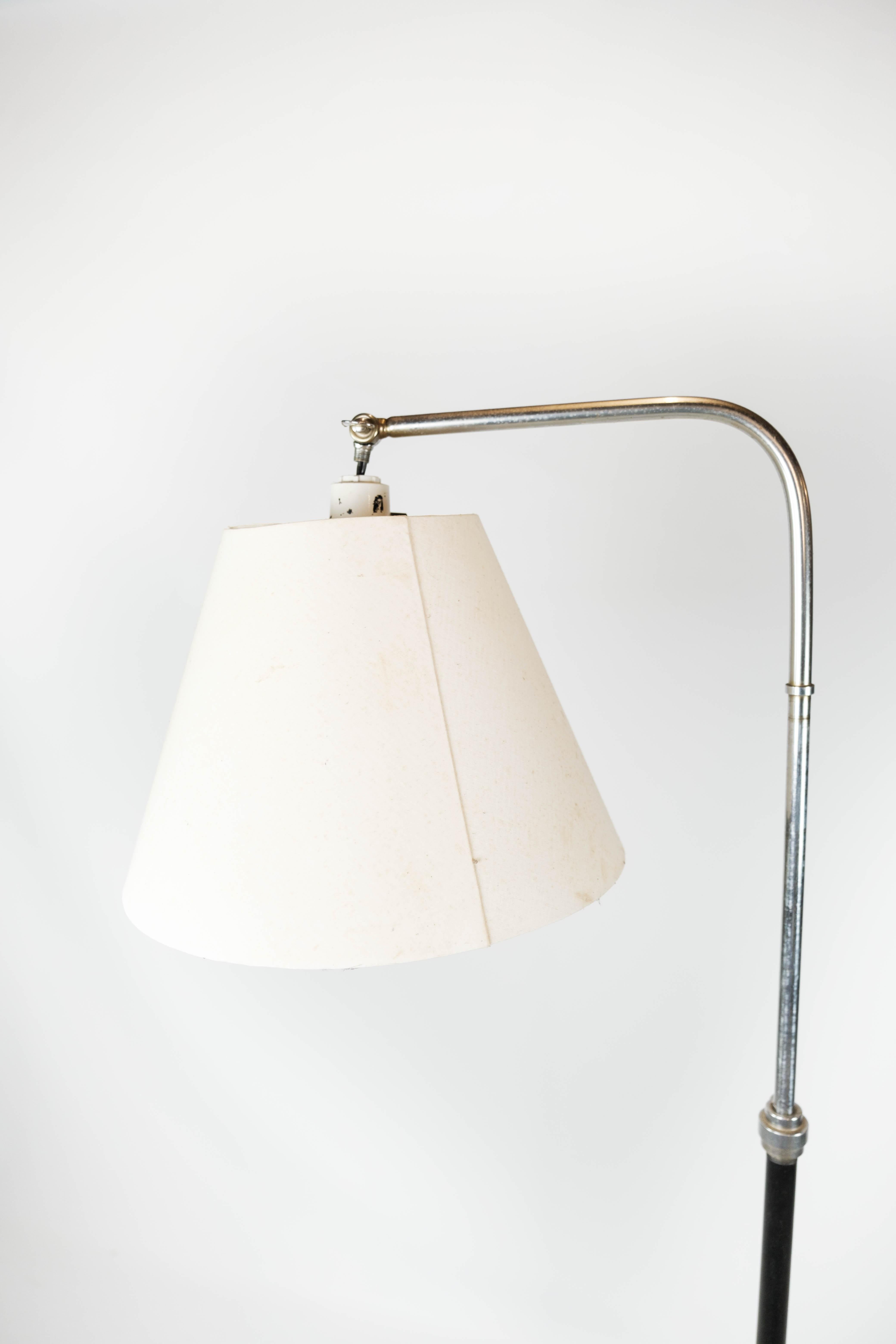 Floor lamp of chrome and black painted metal of Danish design from the 1970s. The lamp is in great vintage condition.