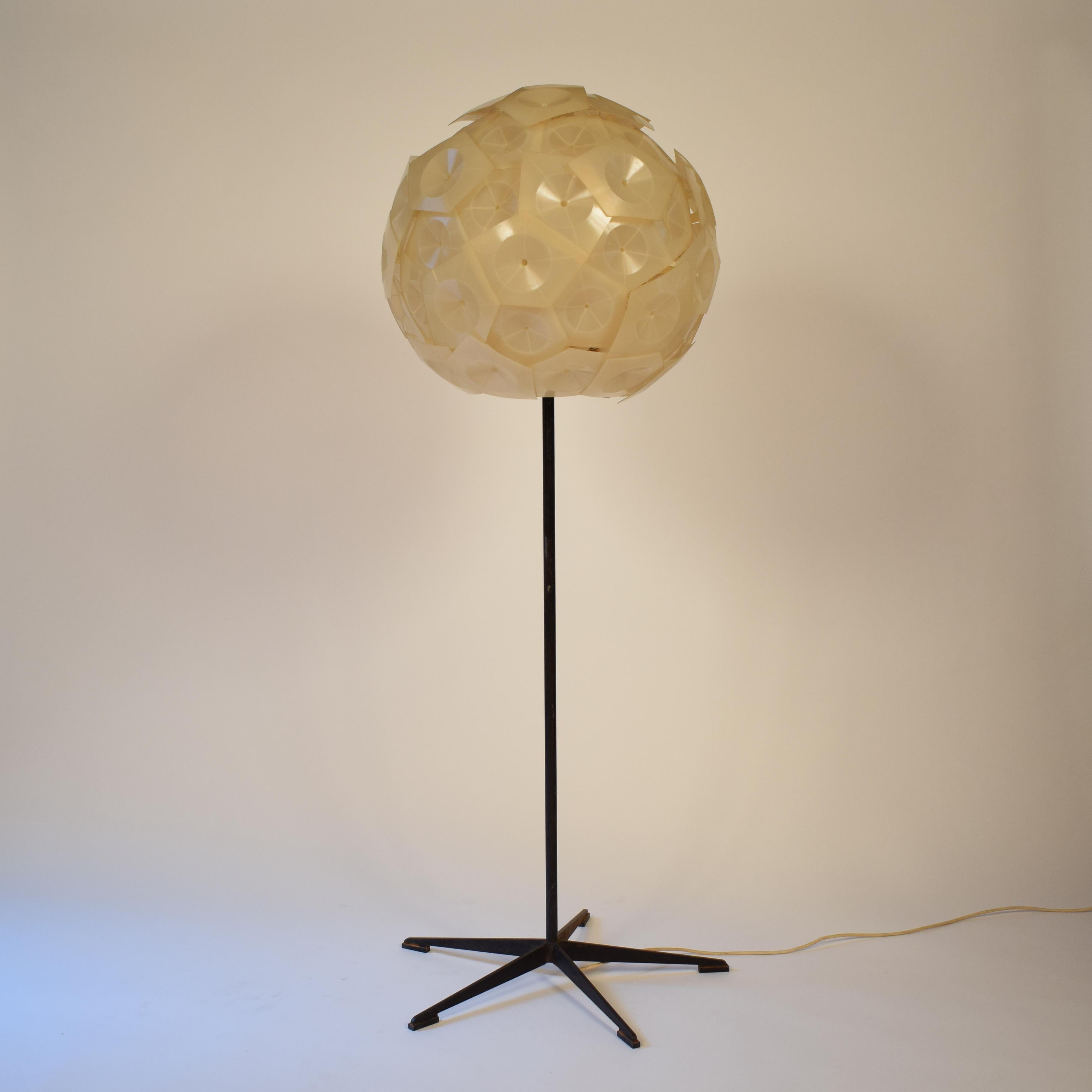 This absolutely rare floor lamp was made by the German designer and artist Günter Ssymmanks in 1956. 
This special lamp was a prototype and was a limited edition of 20. They were never for sale. He just gave it to friends. The base was produced