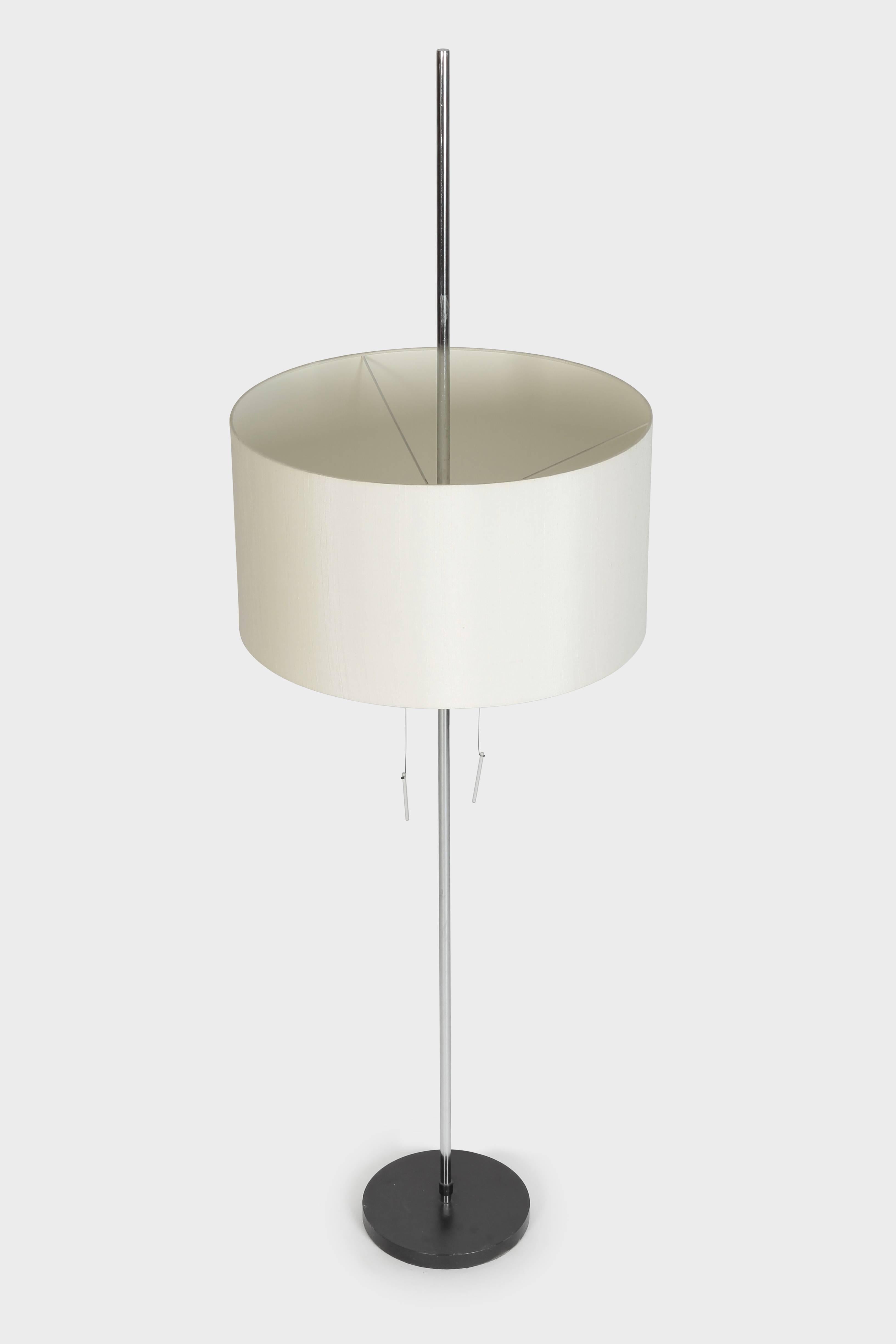 Height adjustable floor lamp manufactured by Swiss Lamps International in the 1960s. The shade is covered with silk. Two bulbs which can be switched on separately.