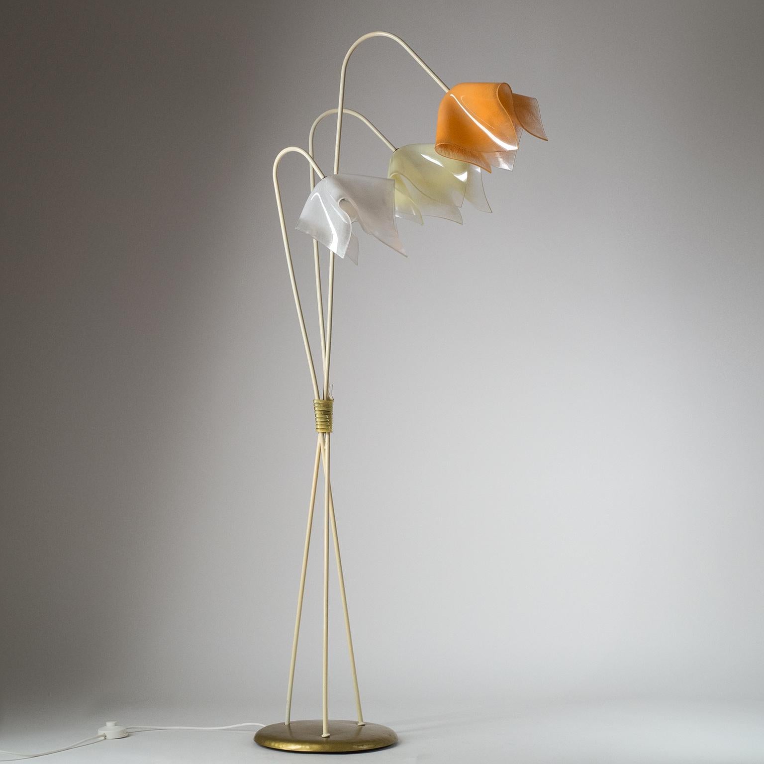 Rare midcentury floor lamp from the late 1950s-early 1960s. Asymetric modernist design with a large weighted base enameled in metallic gold and three stems, each with an abstract floral shade. The acrylic diffusers are coarsely sanded on the inside