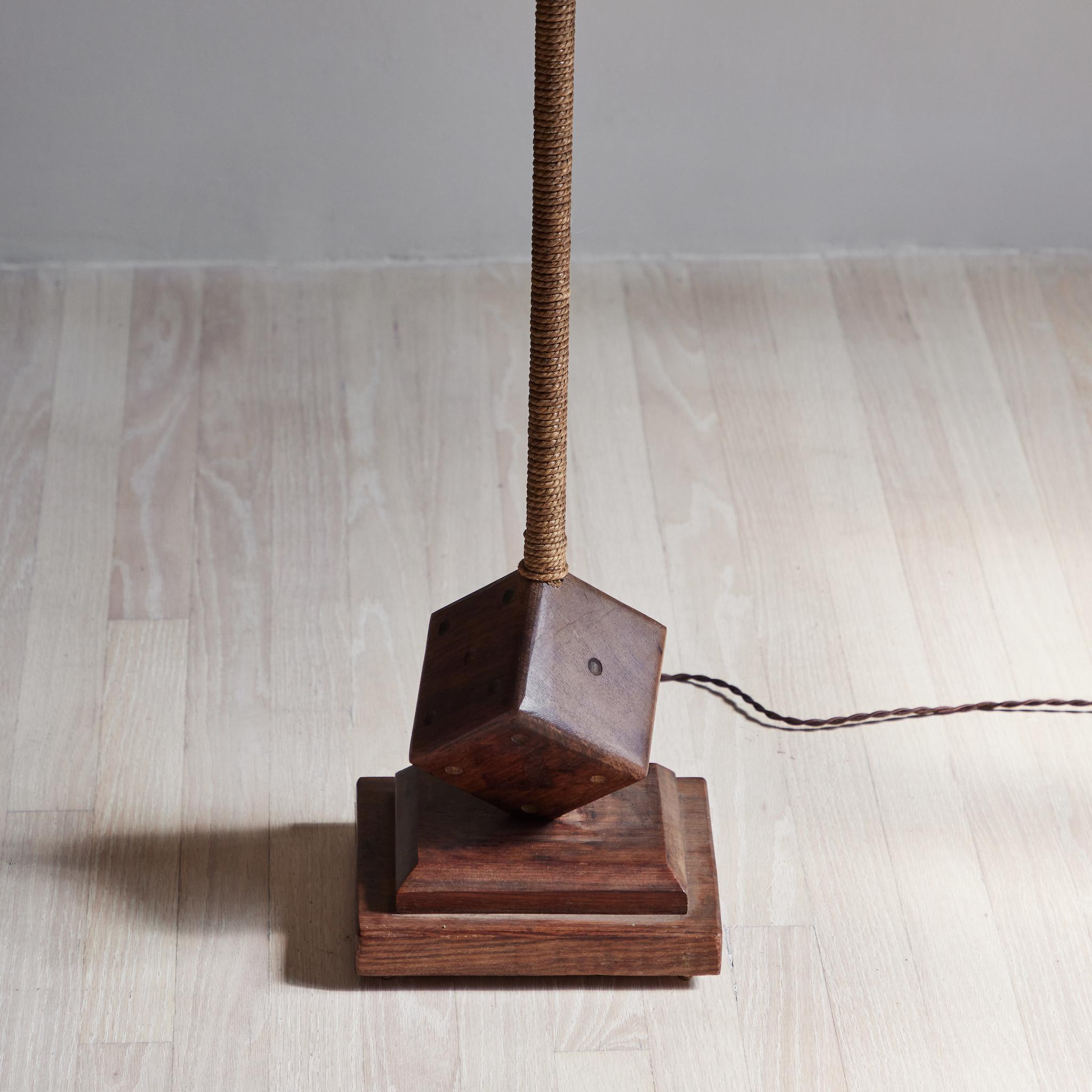 A floor lamp with dice at base with custom shade.