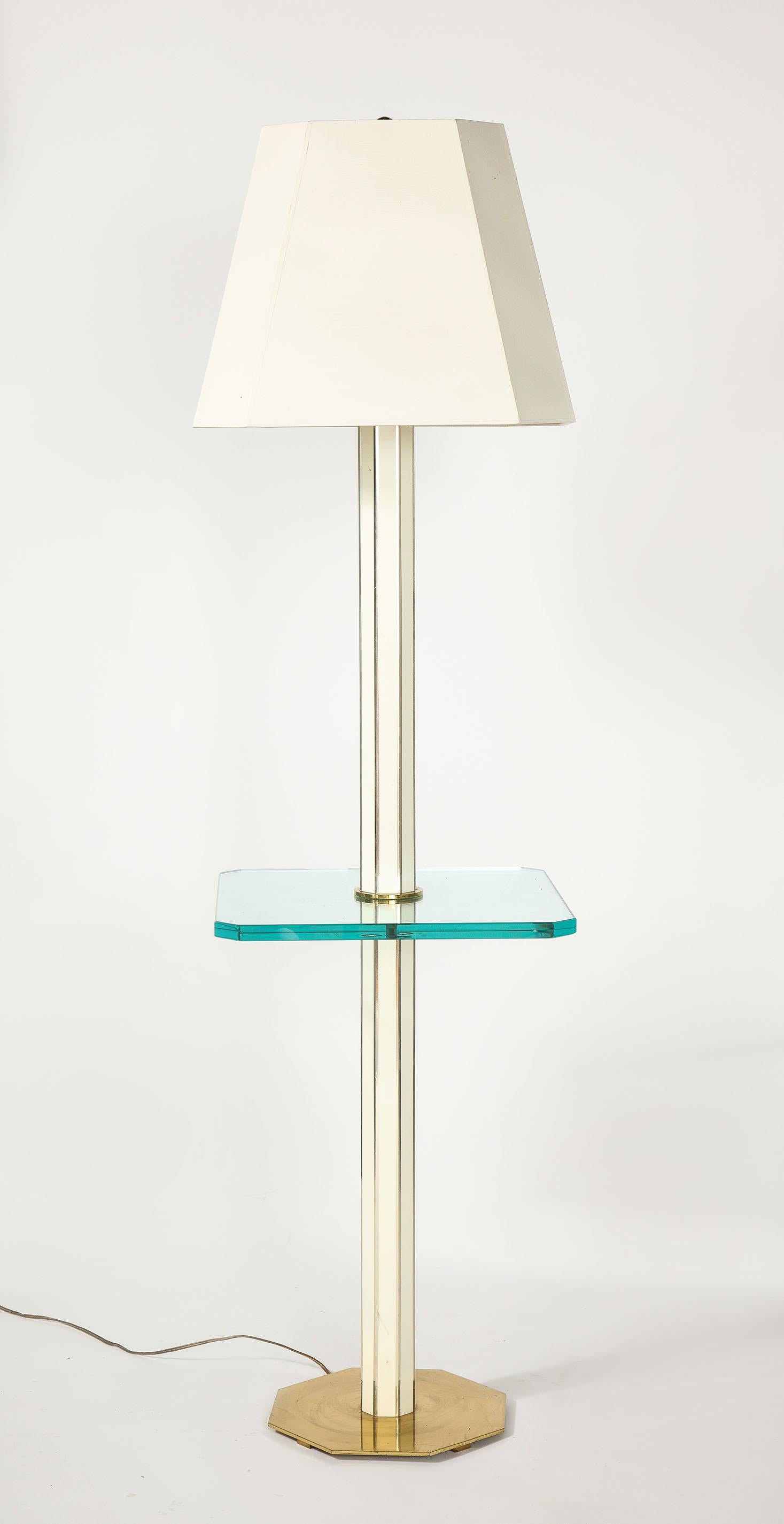 Floor lamps with lacquered wood and glass shelf brass base.